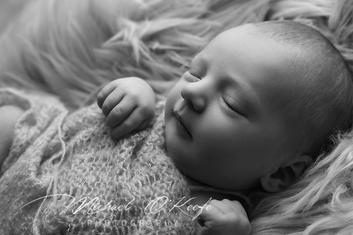 Series of black and white newborn photos showing baby sleeping peacefully in different poses.
