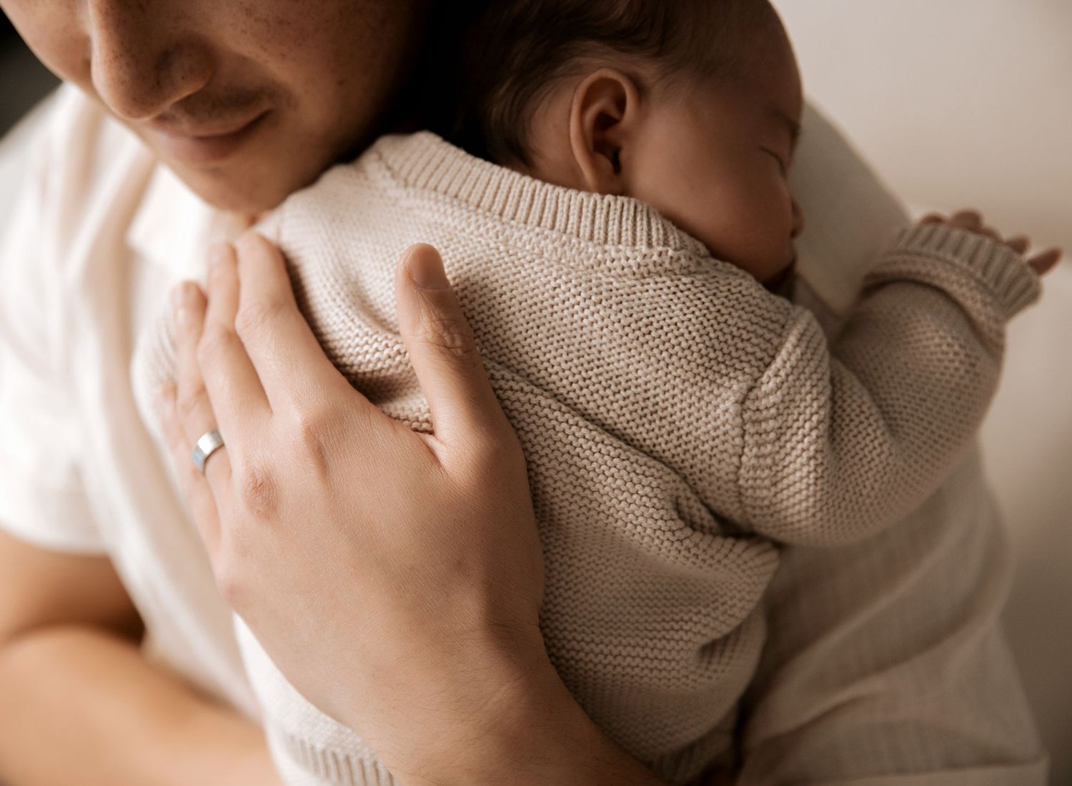 Father and daughter newborn moment. On location newborn photographer.