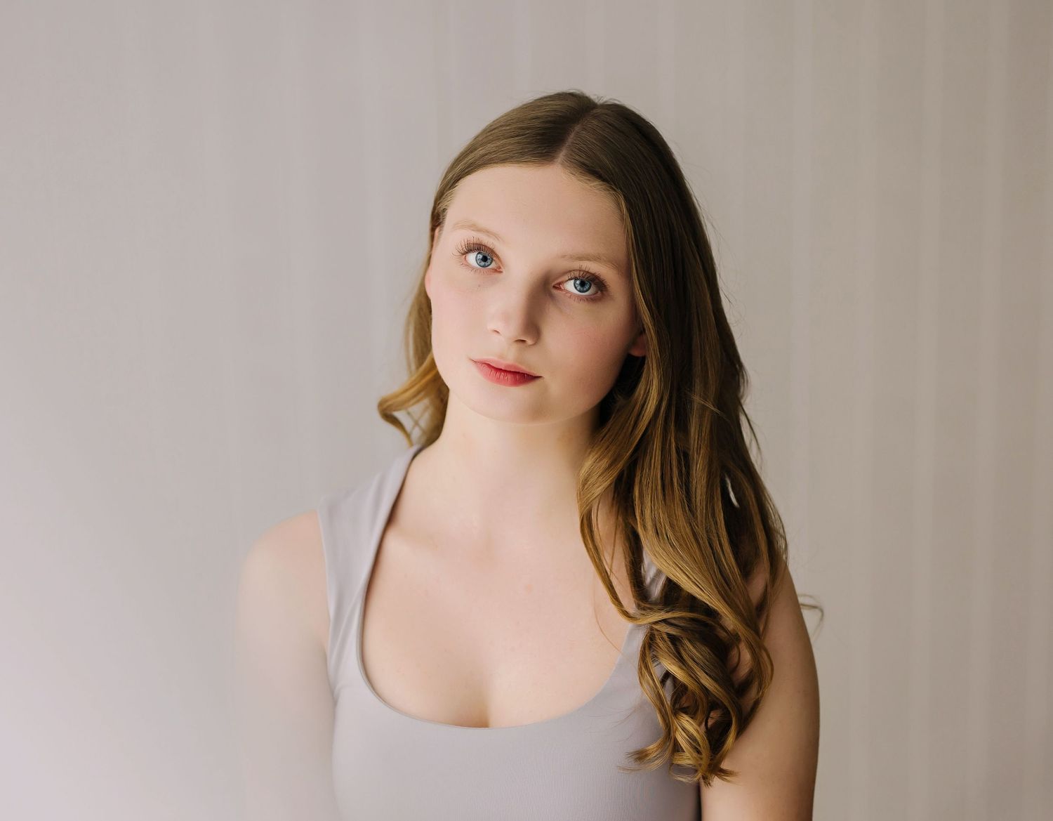 Four matching headshots in muted tones showing subtle pose variations and delicate expressions.