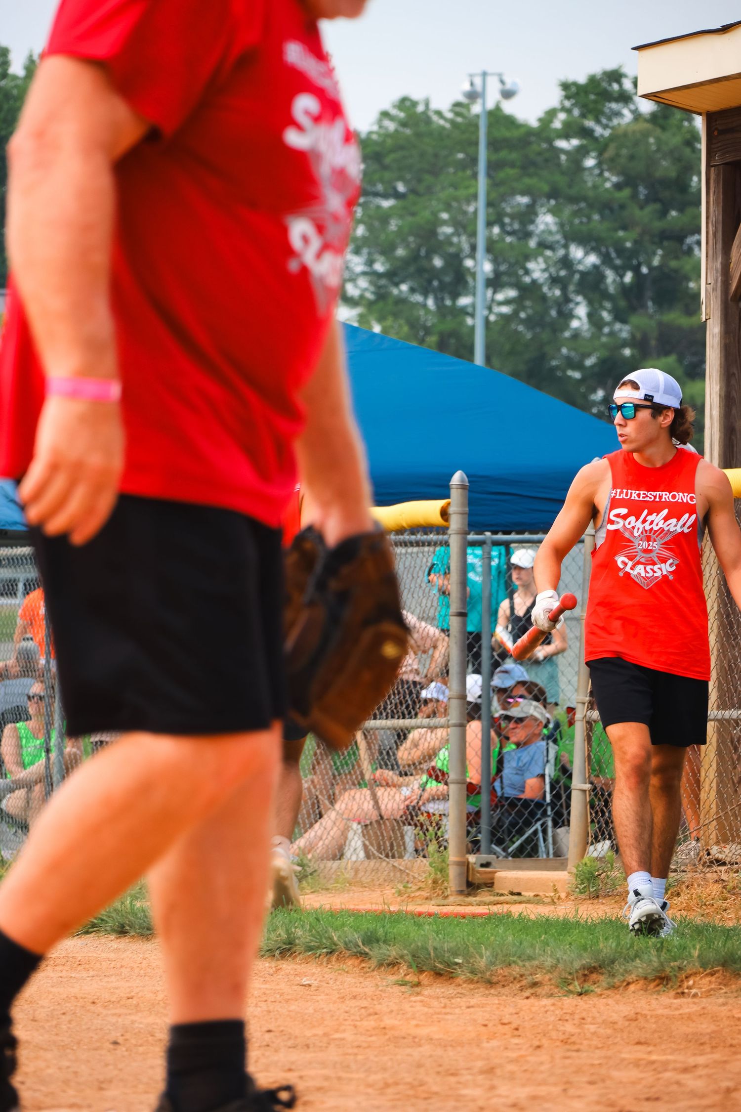 Lukestrong softball walking up to bat.