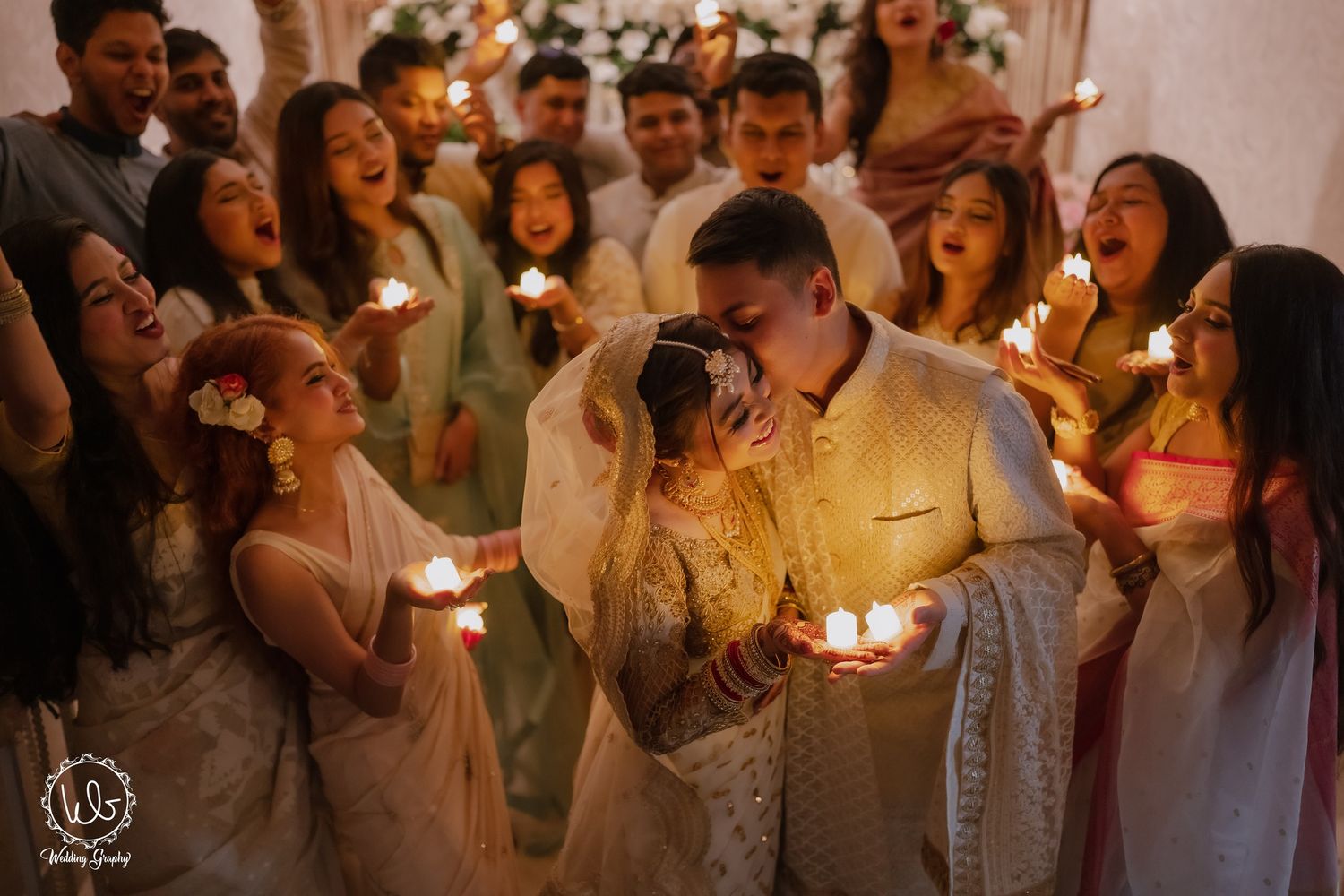 Wedding guests hold sparklers during an evening celebration creating a magical atmosphere at an outdoor reception.