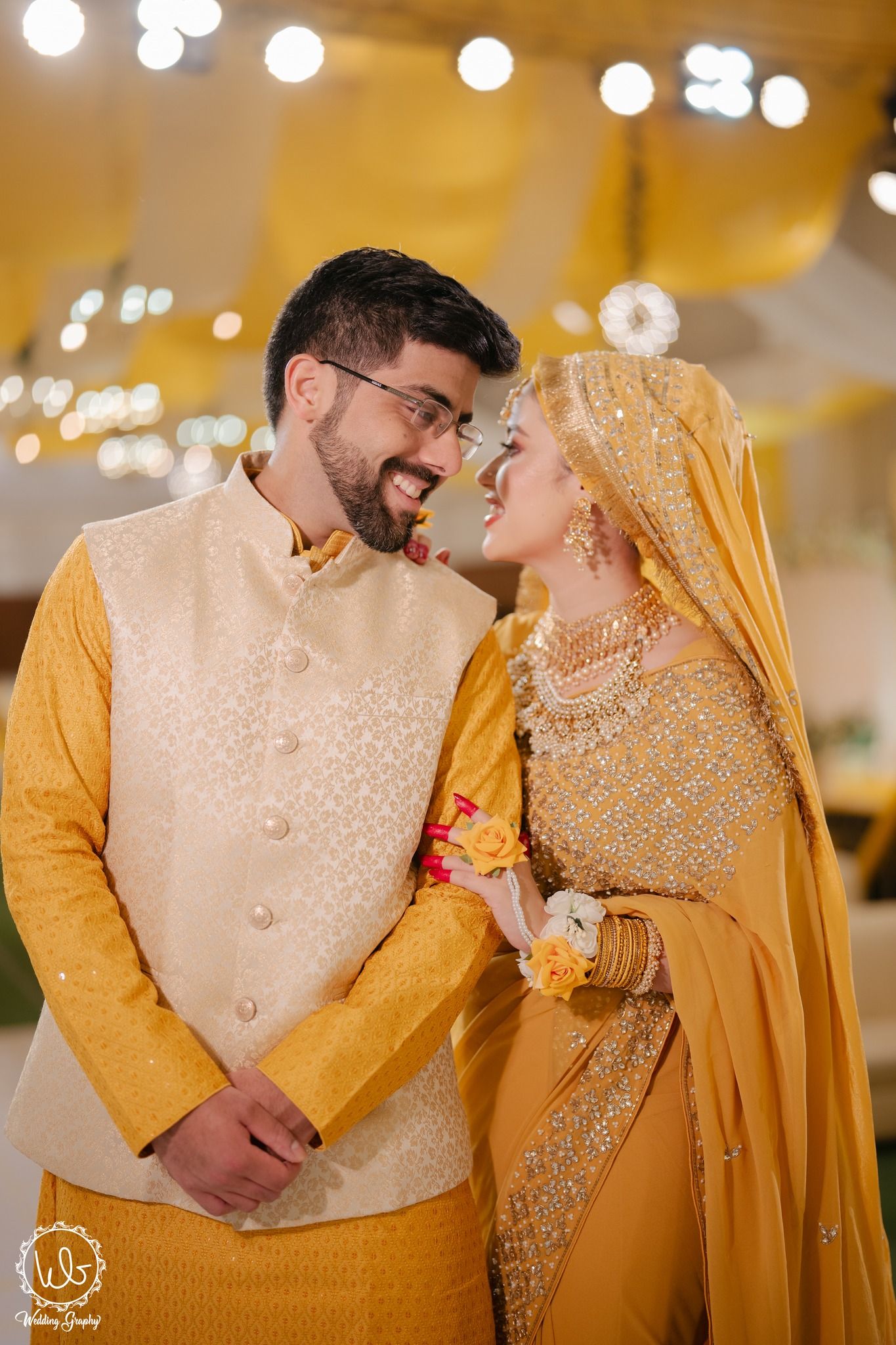 Couple in matching yellow and cream traditional South Asian wedding attire posing together in romantic portraits.