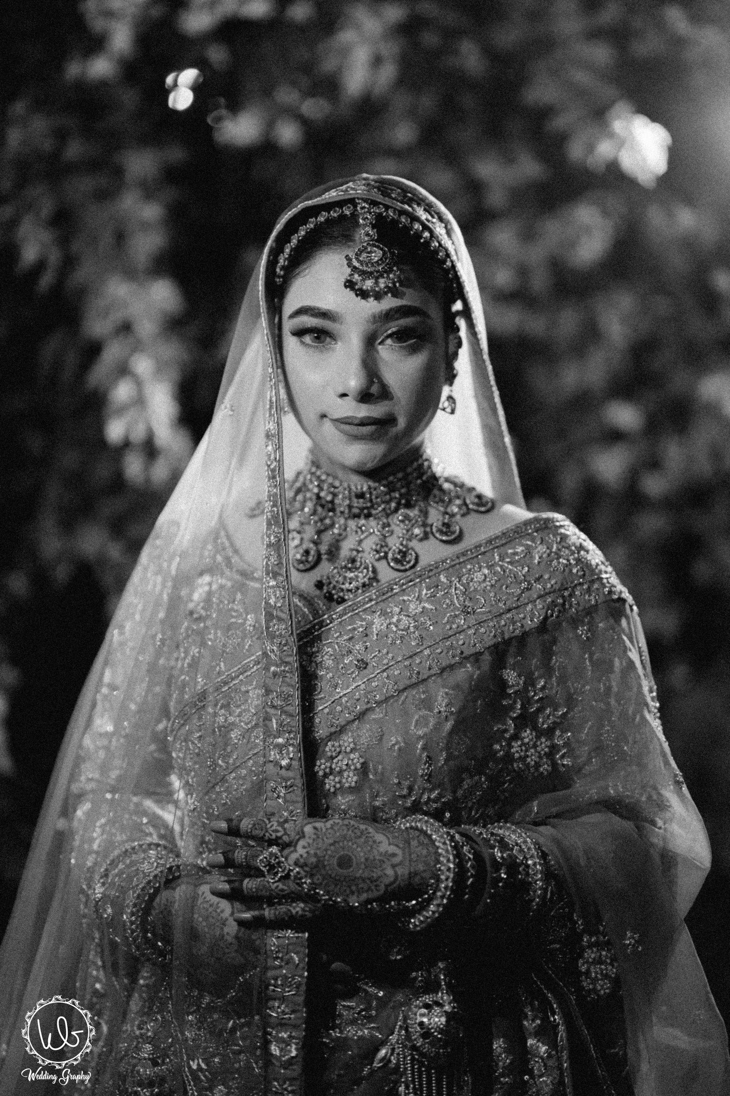 Artistic black and white bridal portraits showcasing detailed embroidery and traditional veil.