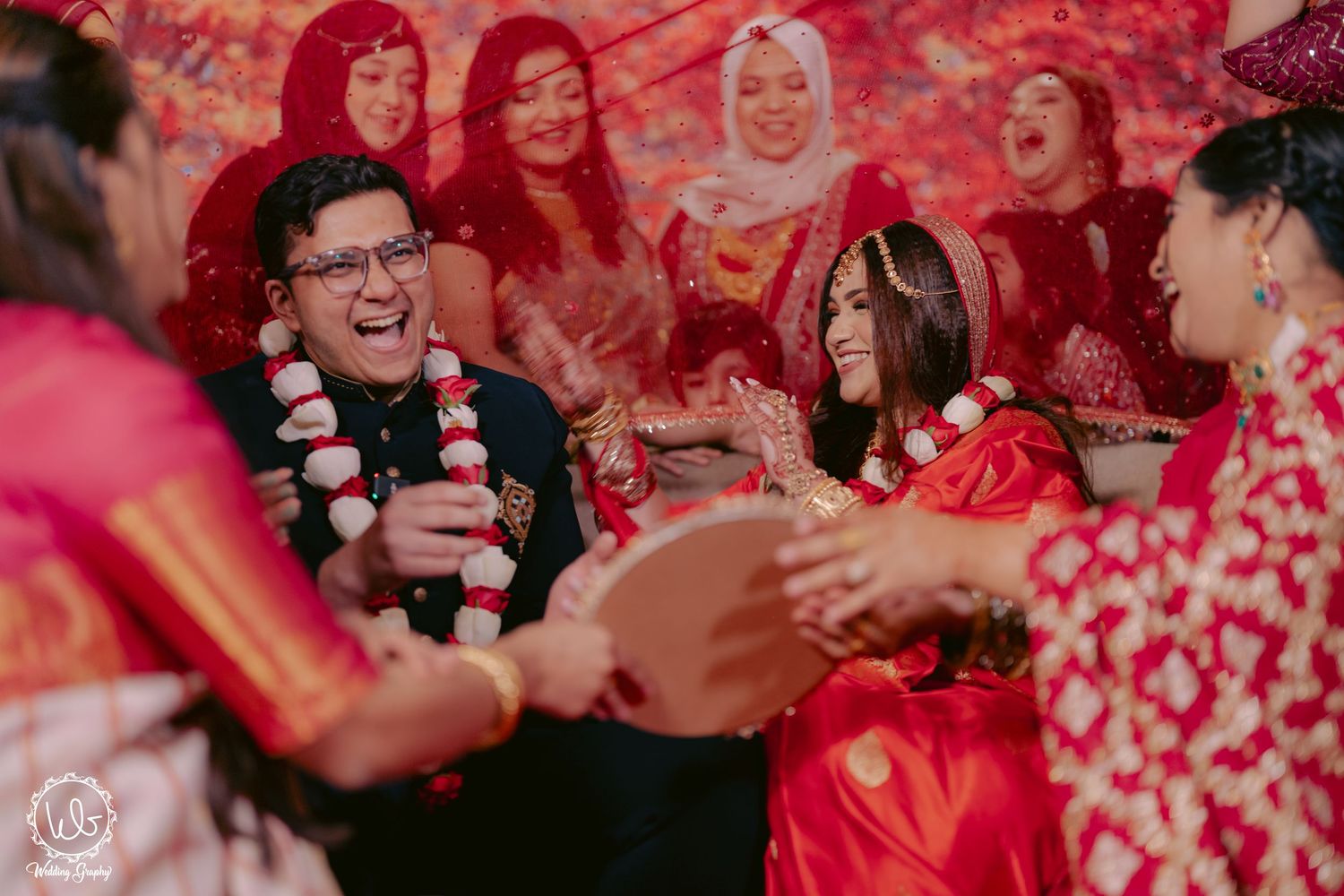 Wedding celebration with vibrant red decor and festive atmosphere.