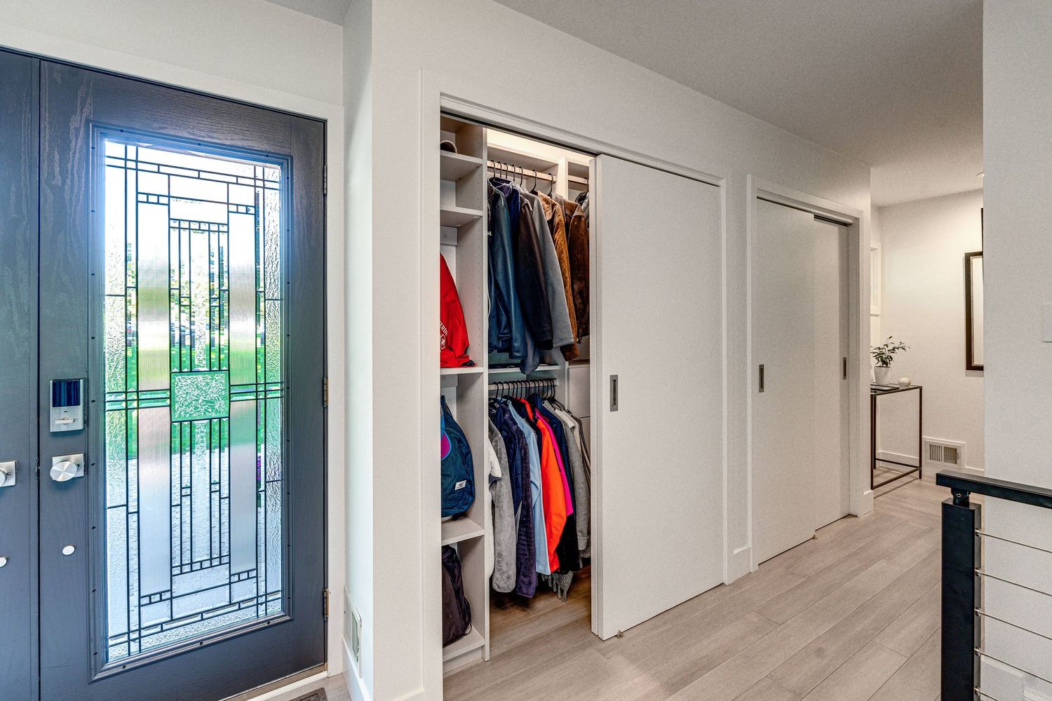 Modern hallway with custom storage and decorative window features.