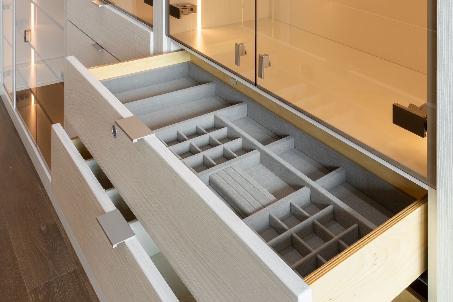 Custom drawer organizers with compartments for accessories and jewelry storage.