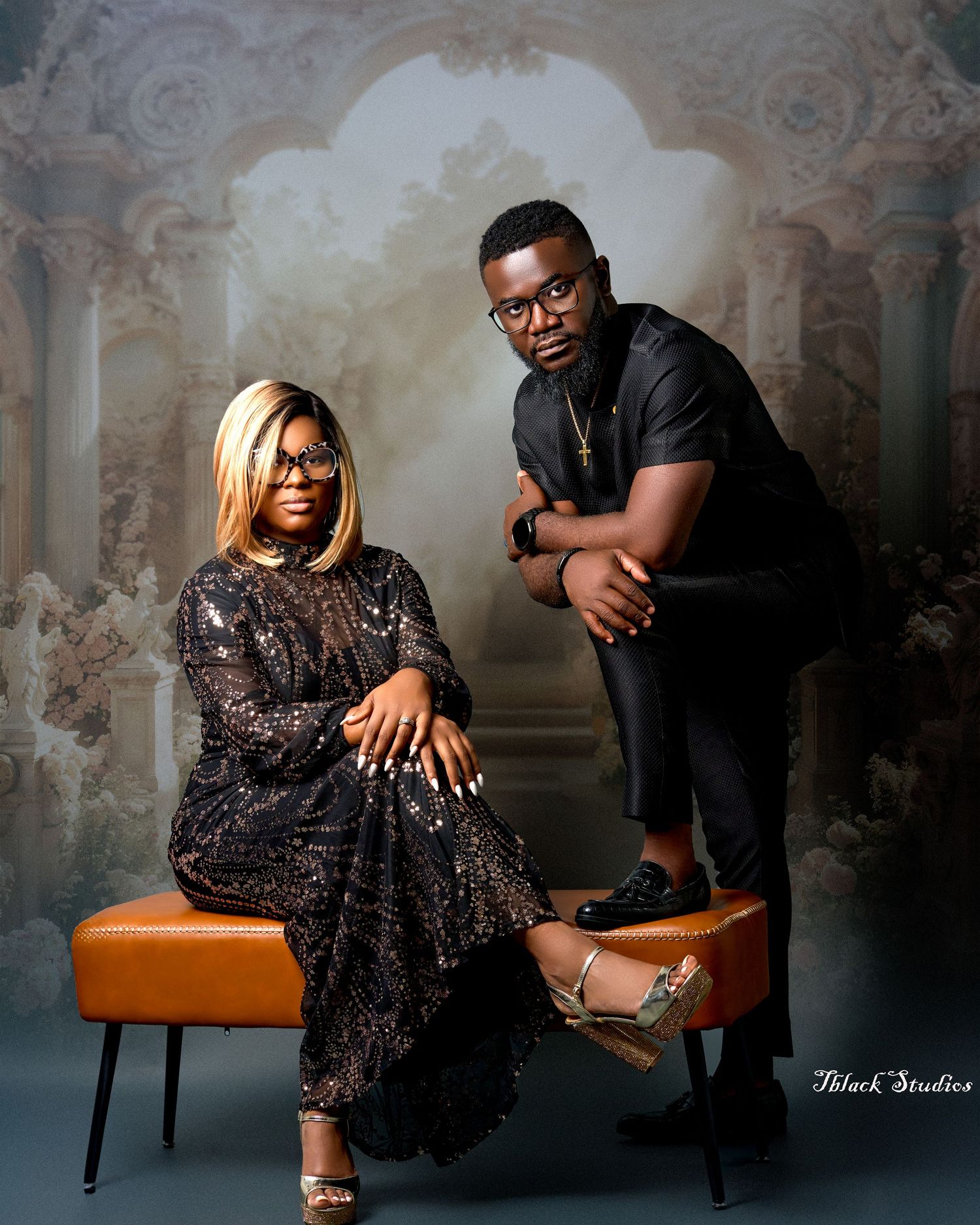 Elegant studio portraits featuring sparkly formal wear and leather seating against vintage backdrop.