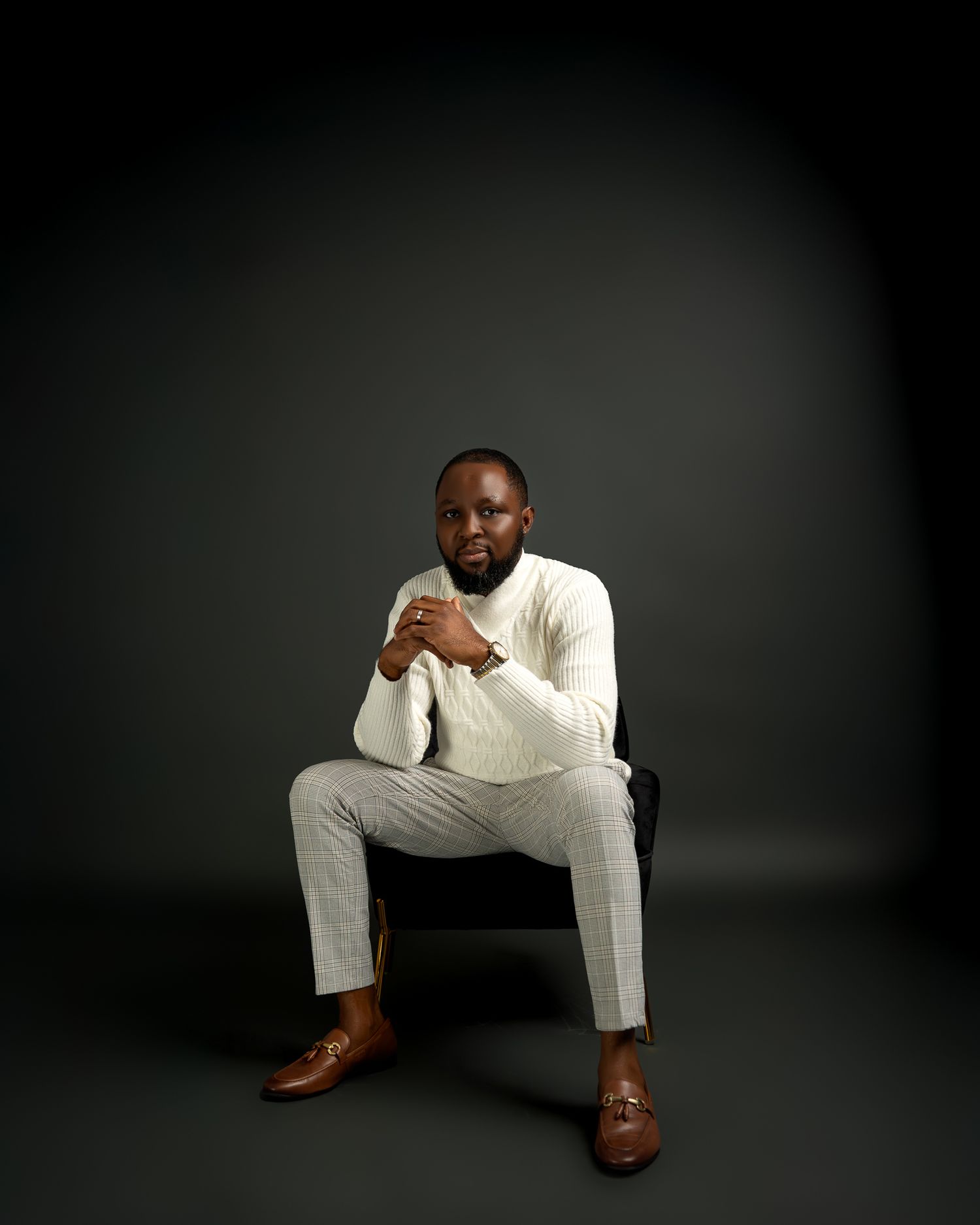 A stylish portrait session with someone wearing an all-white outfit and brown leather shoes.