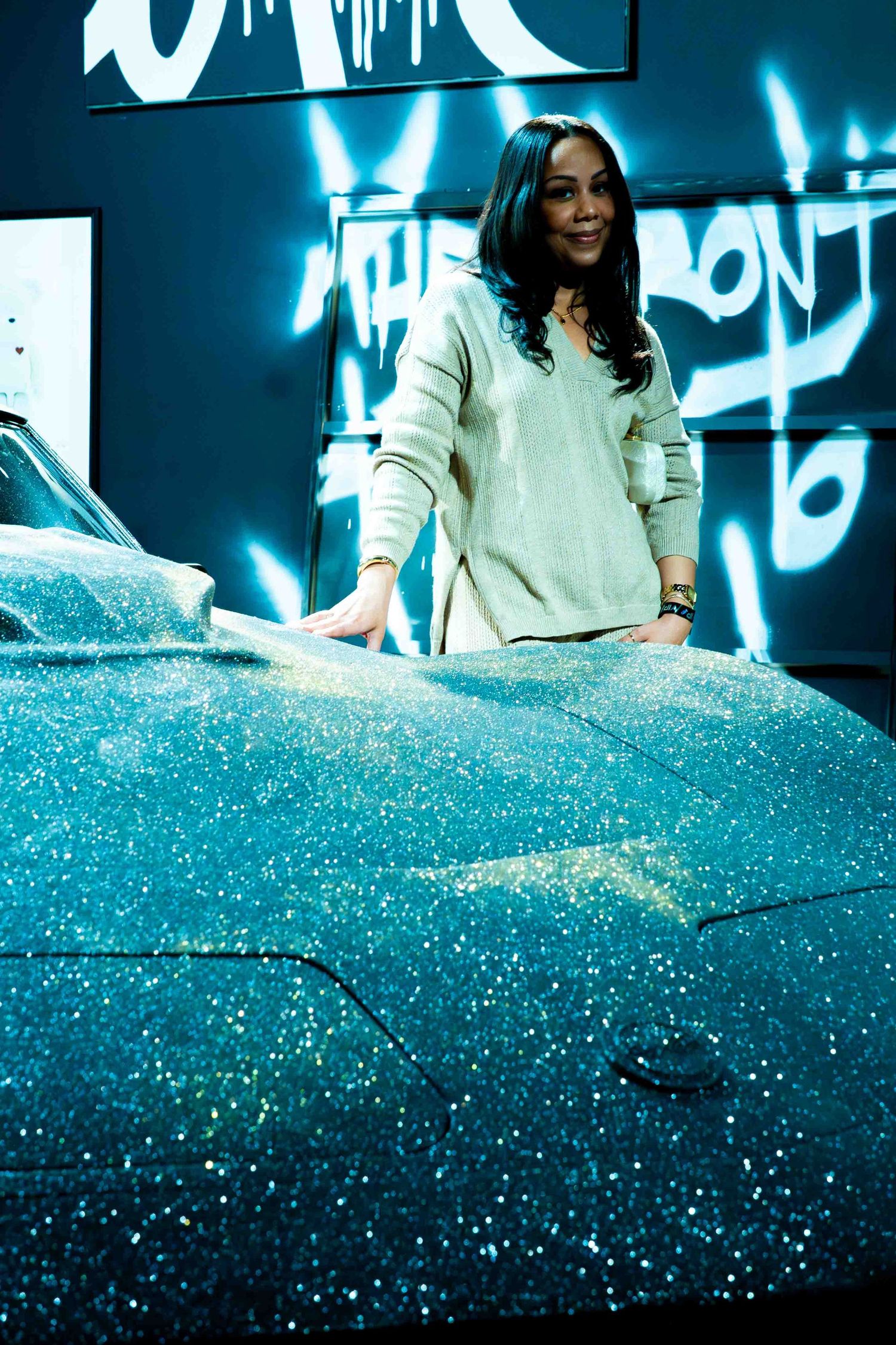 Glittering surface with blue neon lighting creates dramatic atmospheric display.