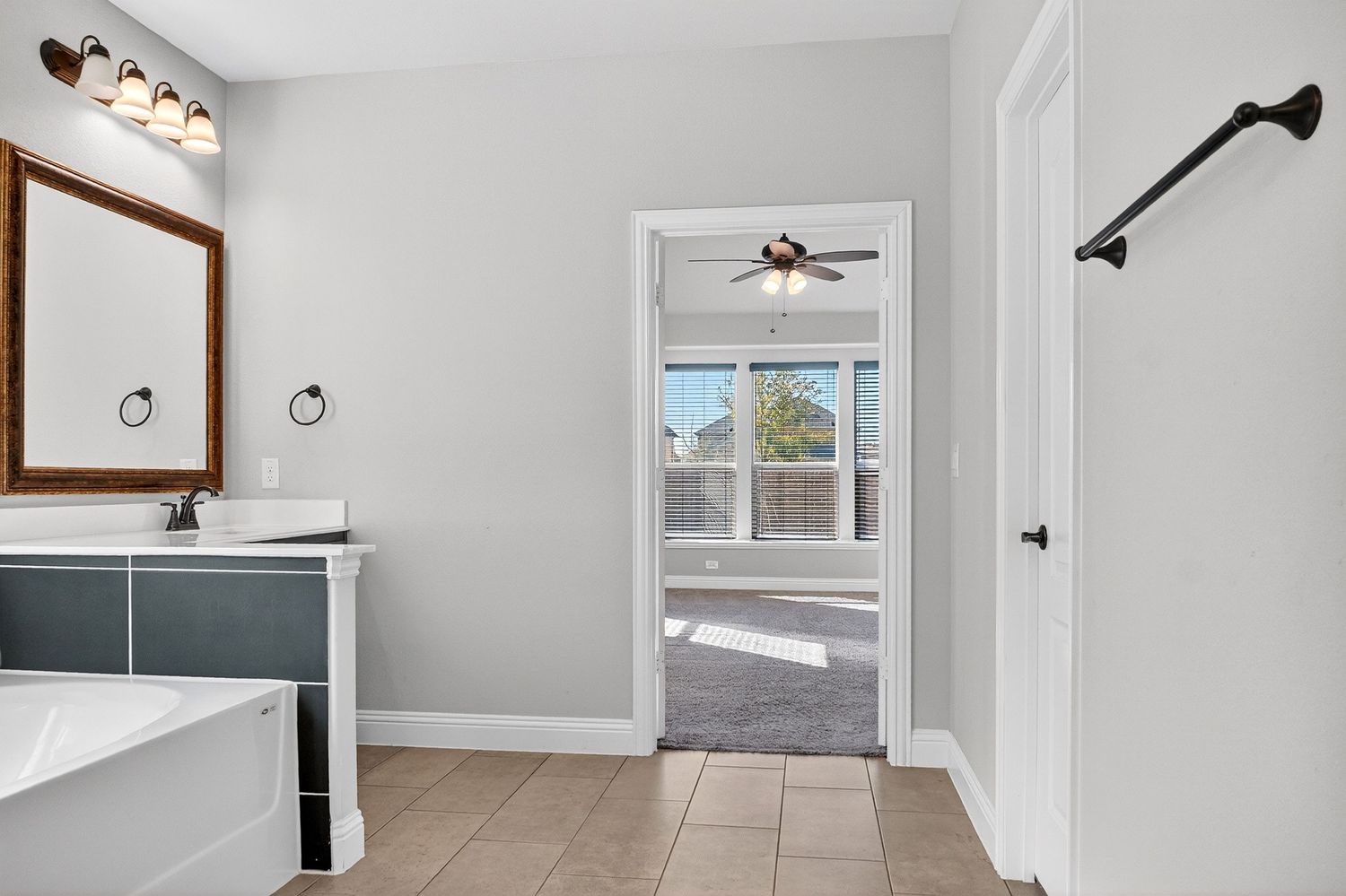Bright interior hallway with recessed lighting, white walls, and modern light fixtures.