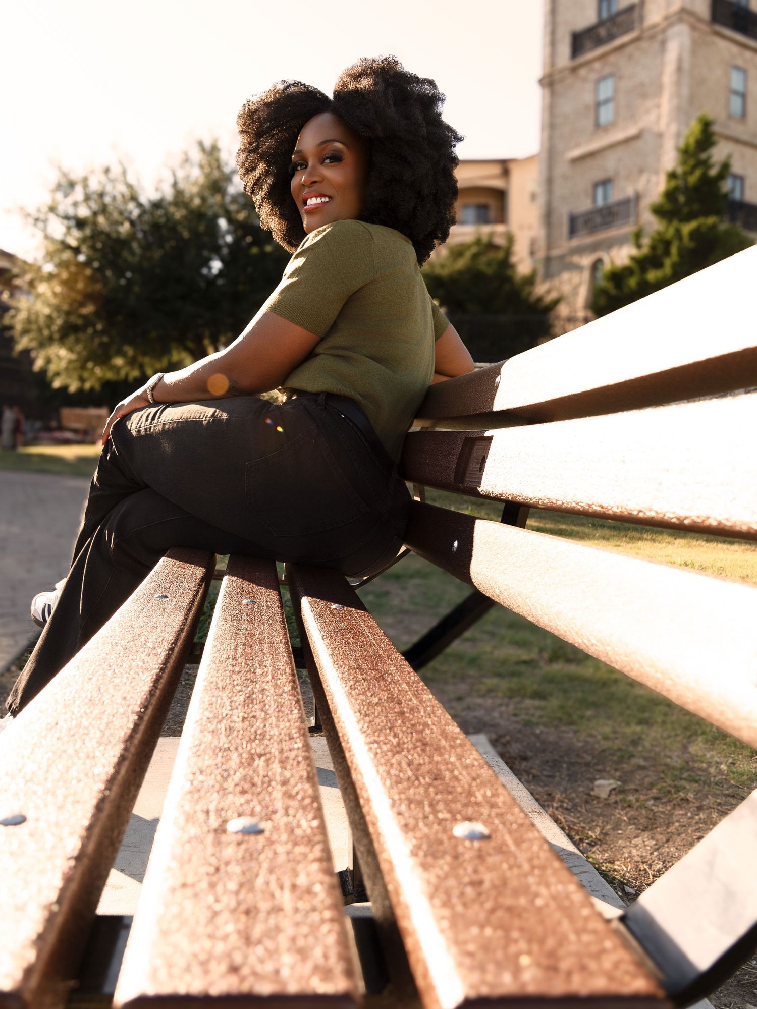 Relaxed portrait session on a wooden bench in casual athleisure wear.