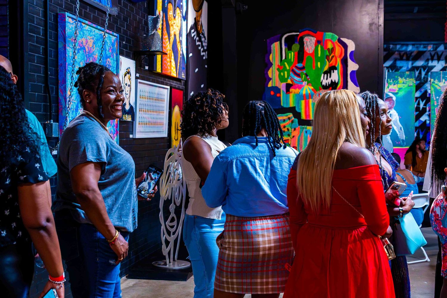 Crowd of visitors in casual attire exploring an indoor exhibition space.