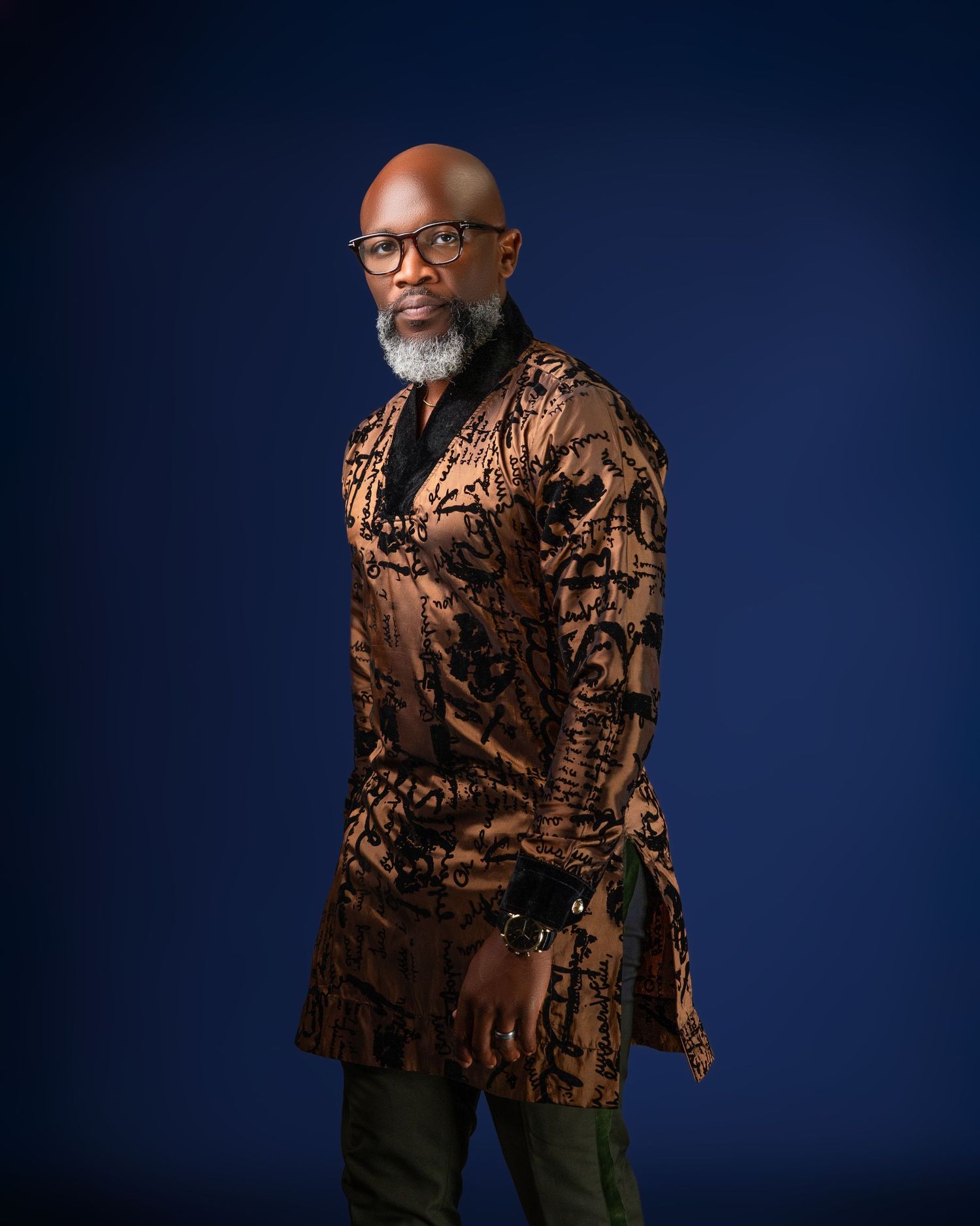 Fashion portrait featuring a textured bronze colored jacket in professional studio setting.