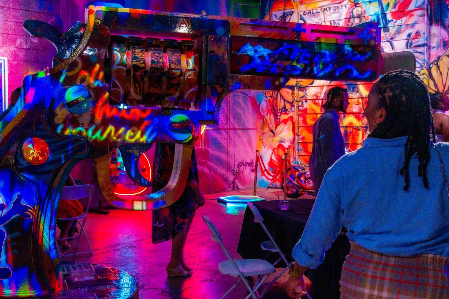 Nightclub scene with neon pink and blue lighting creating an energetic atmosphere.
