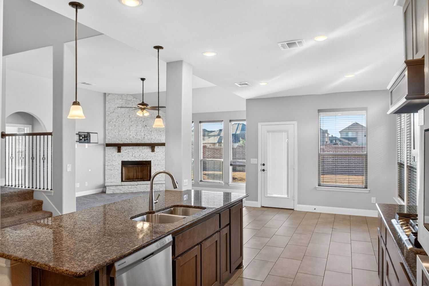 Contemporary kitchen and dining area with extended breakfast bar and recessed lighting.
