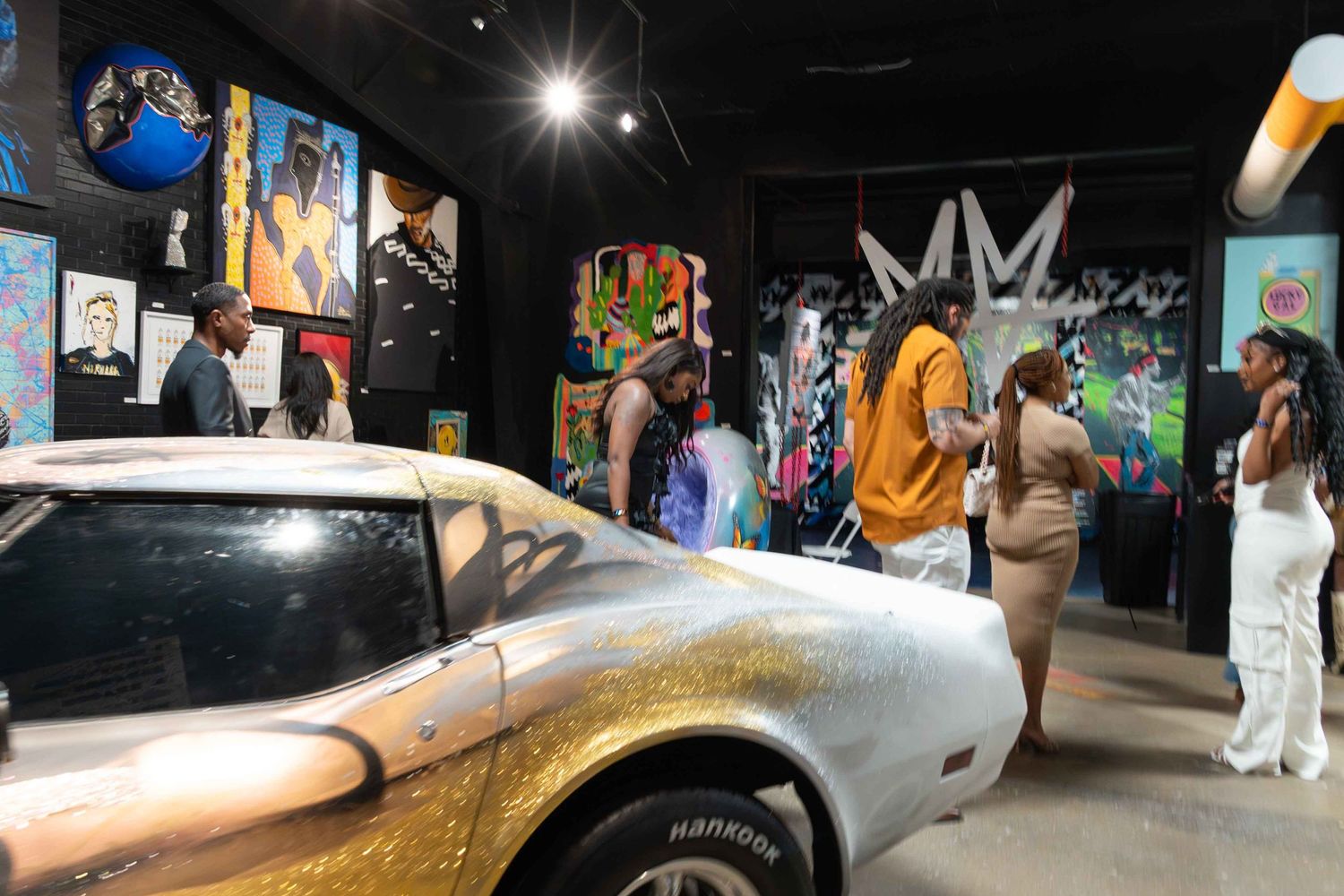 Art gallery interior with illuminated displays and installations creating dramatic shadows.