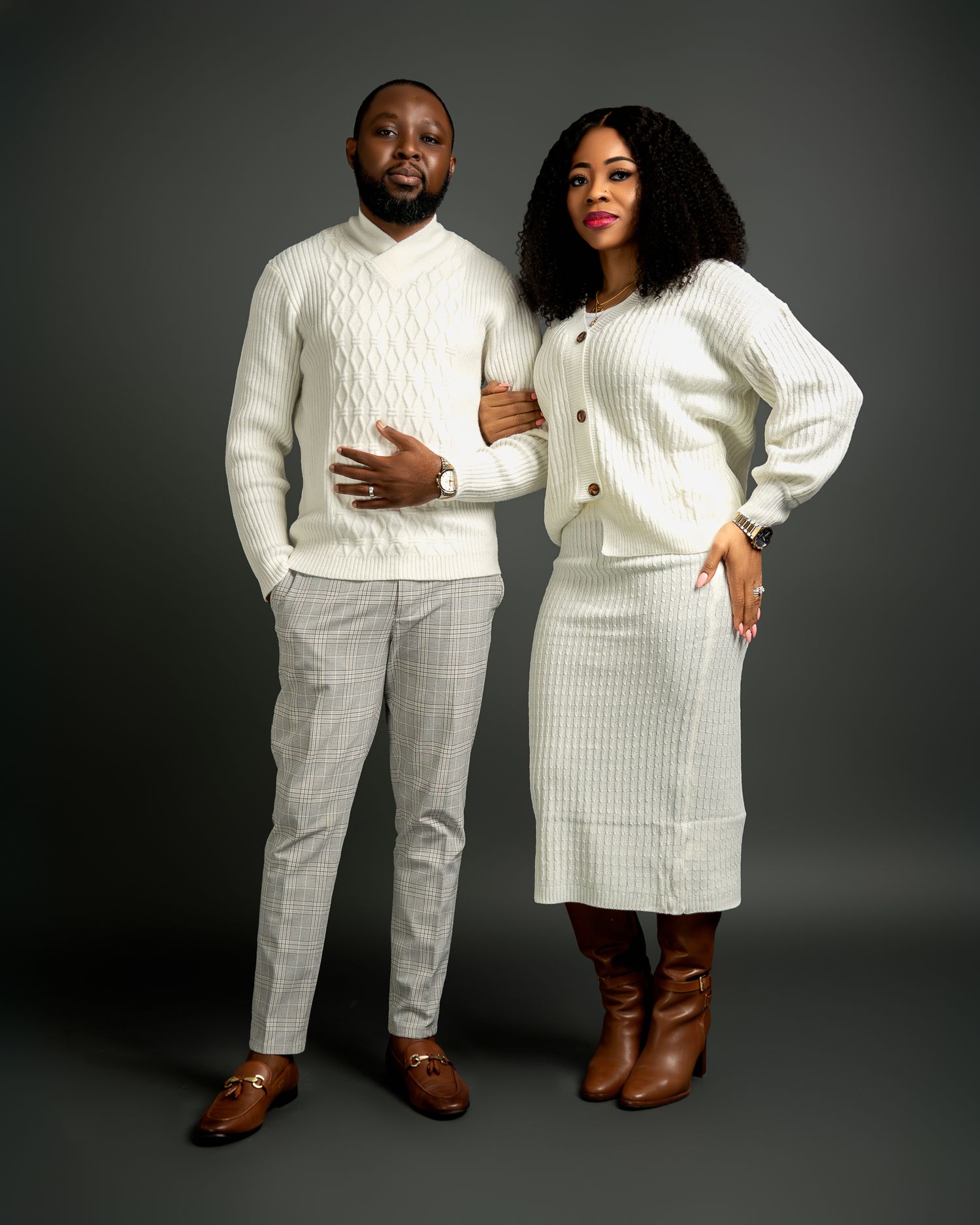 A coordinated couple's photoshoot featuring matching white knit outfits and brown boots.