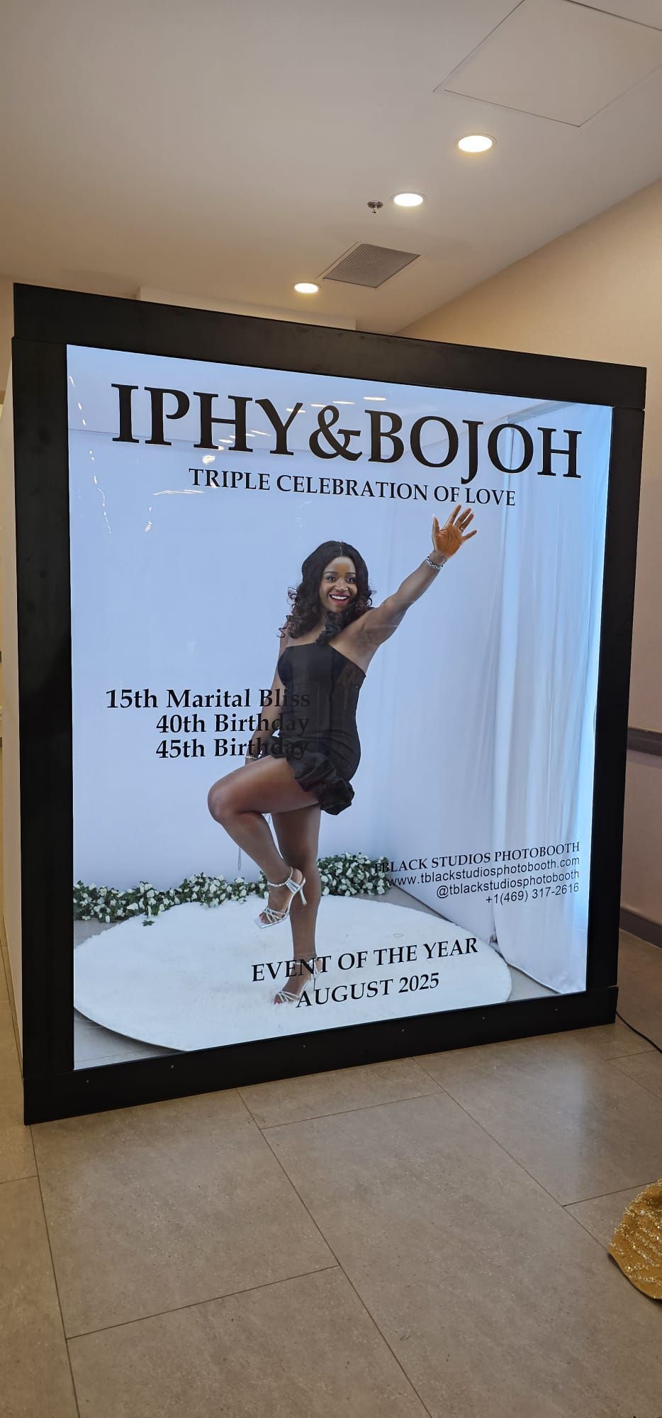 Digital display screens showing event details and celebration photos in white interior.
