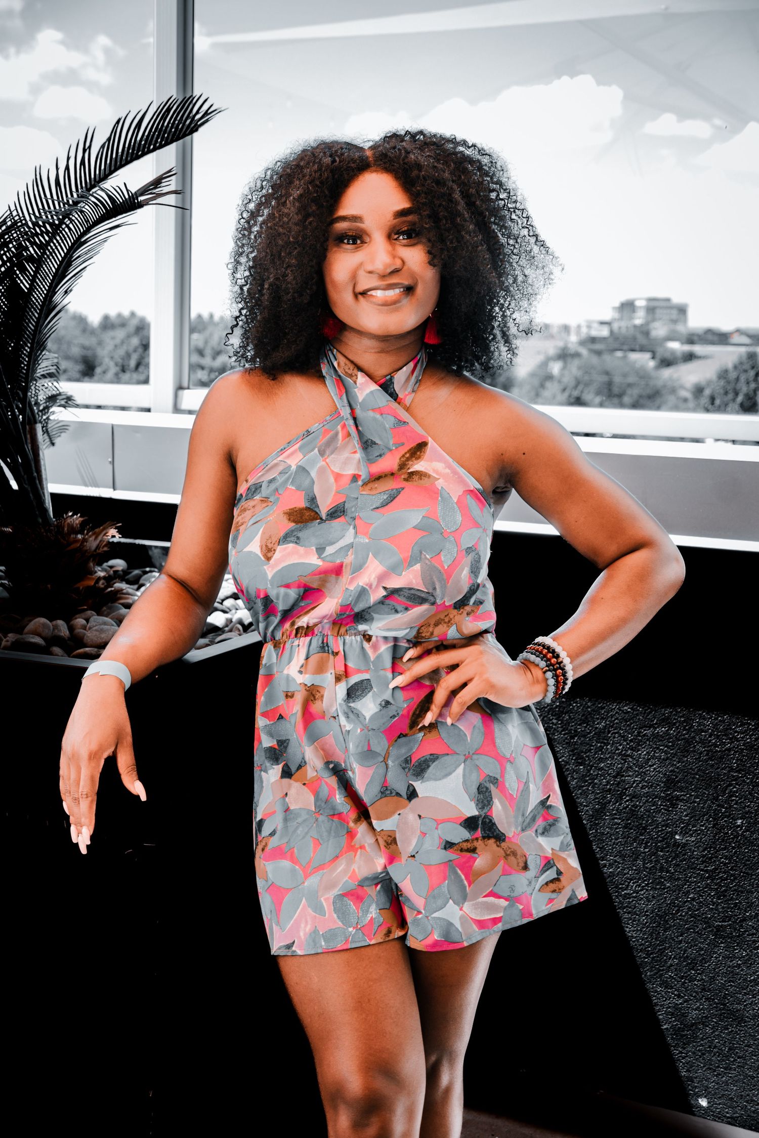 A floral romper outfit photographed in multiple poses against a bright window.