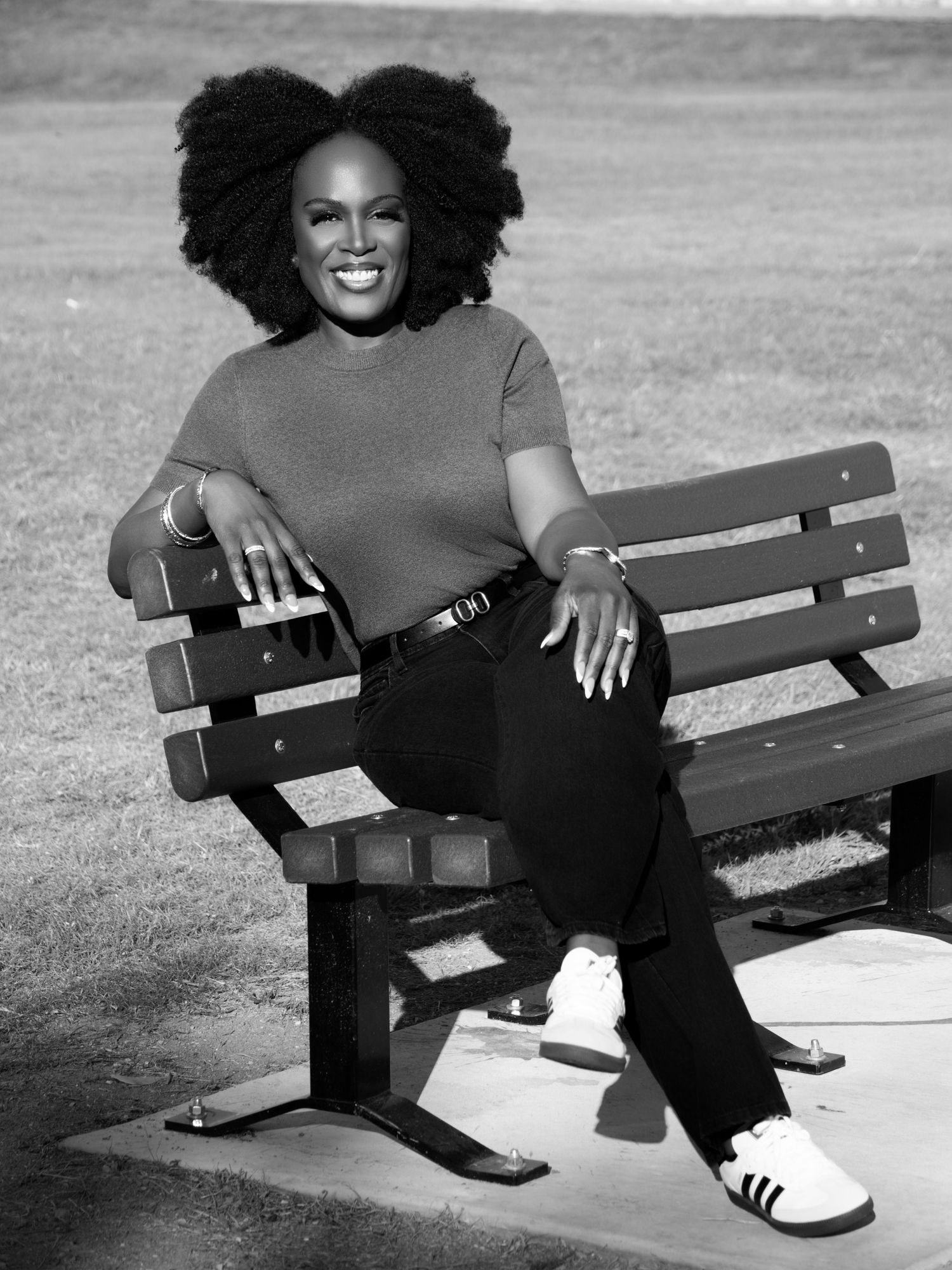 Black and white portrait series on a park bench showing casual street style.