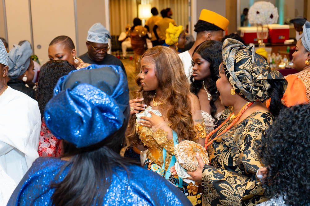 Candid shots of wedding guests interacting during reception in colorful African attire.