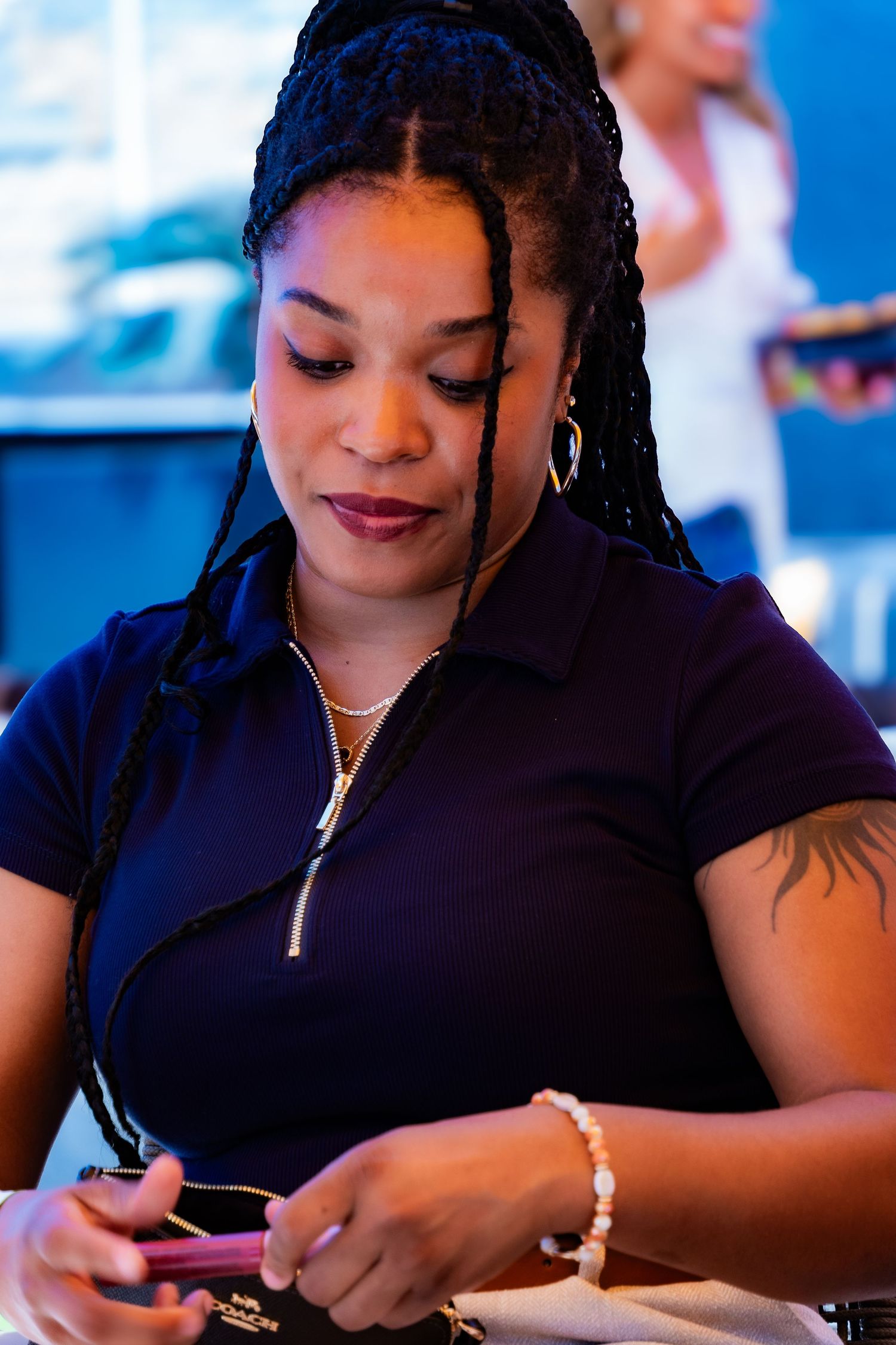Casual portrait series showing jewelry details and a black zip-front top.
