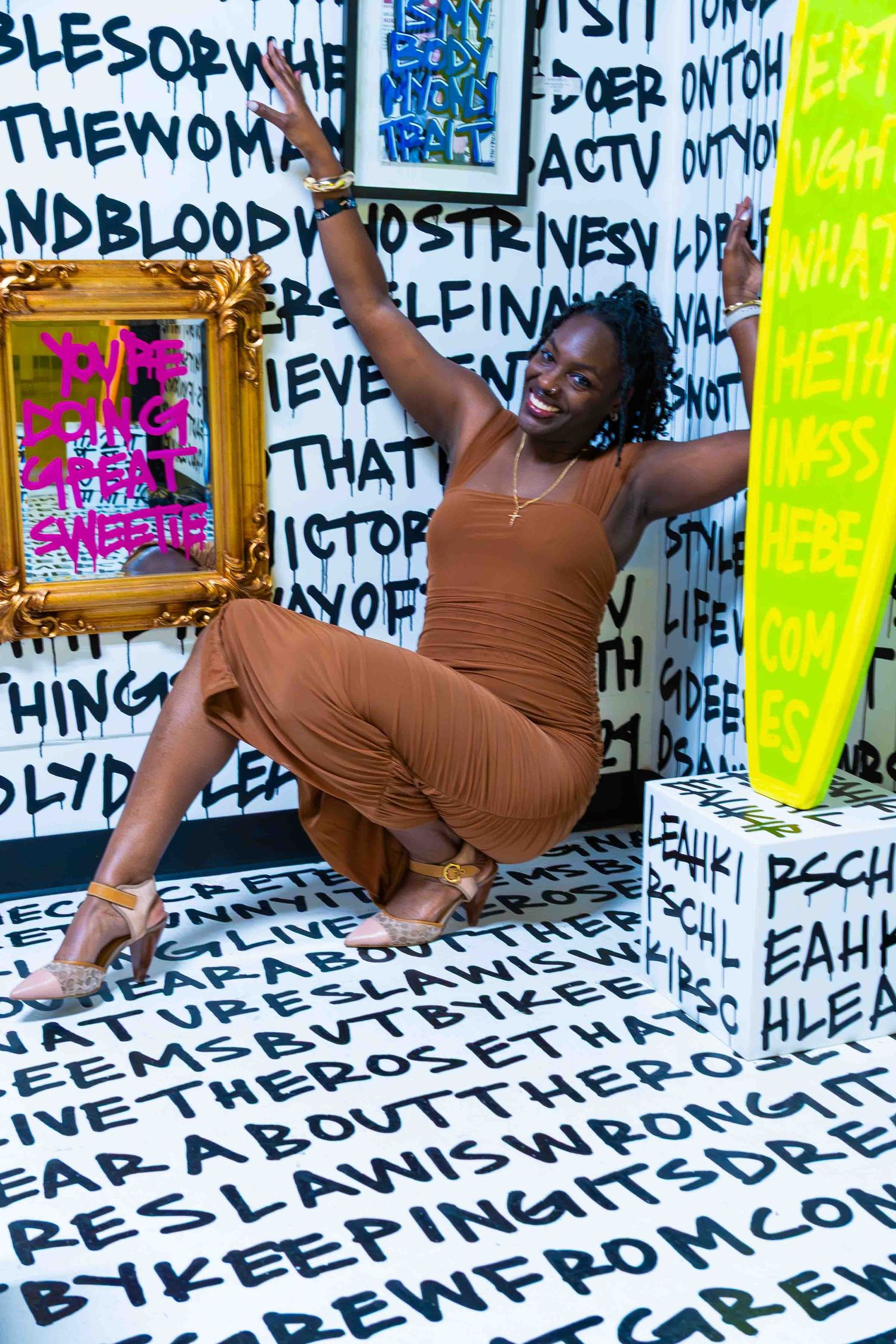 Dynamic performance captured against white wall covered in black text art.