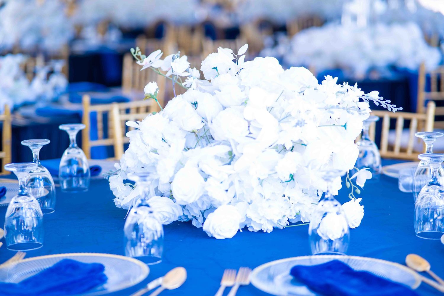 Decorative white floral arrangements on a blue background creating an elegant display.