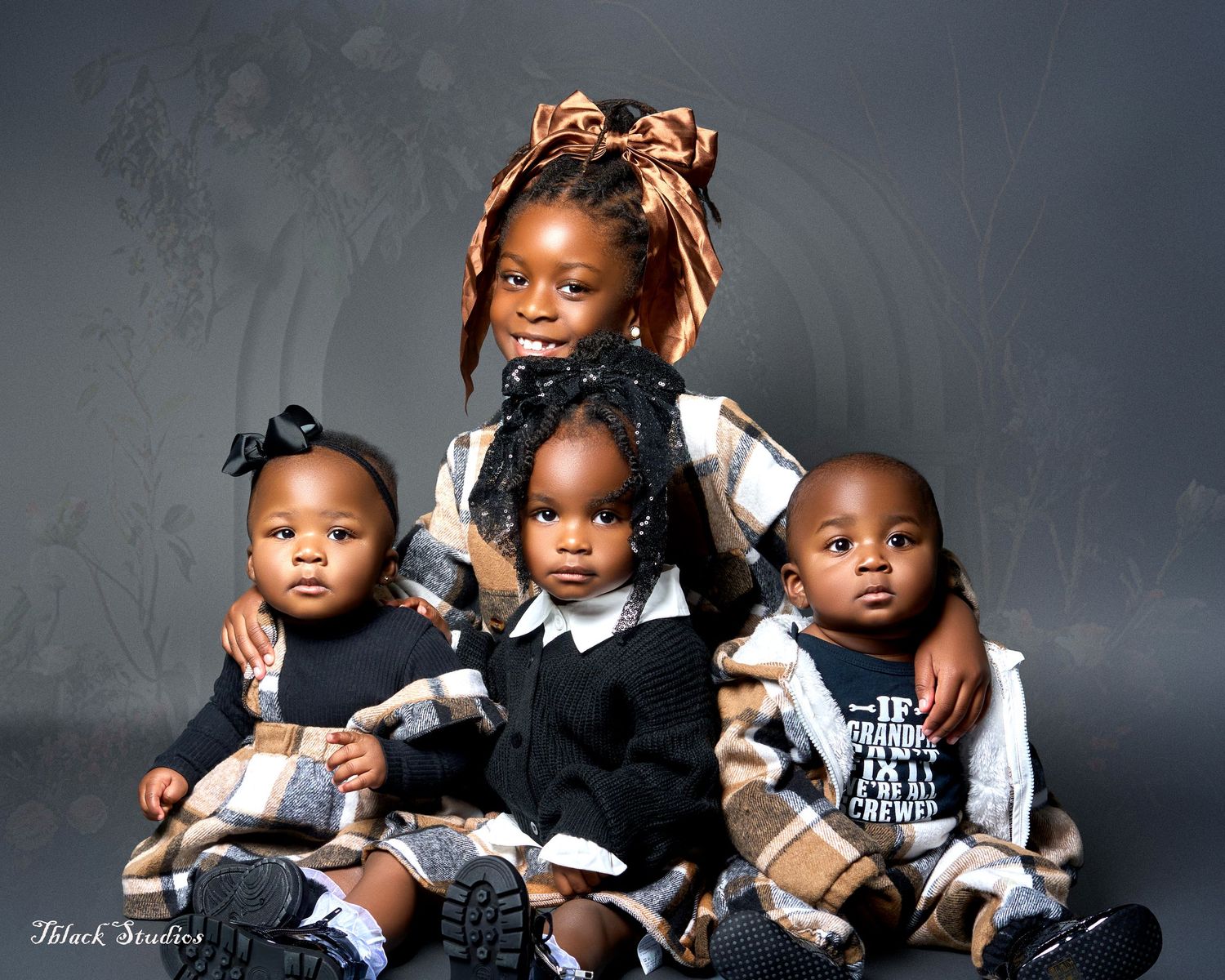 Series of artistic family portraits with children in coordinated outfits against dark backdrop.