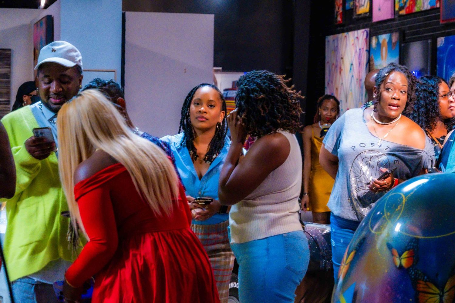 People mingling at an indoor social event with bright ambient lighting.