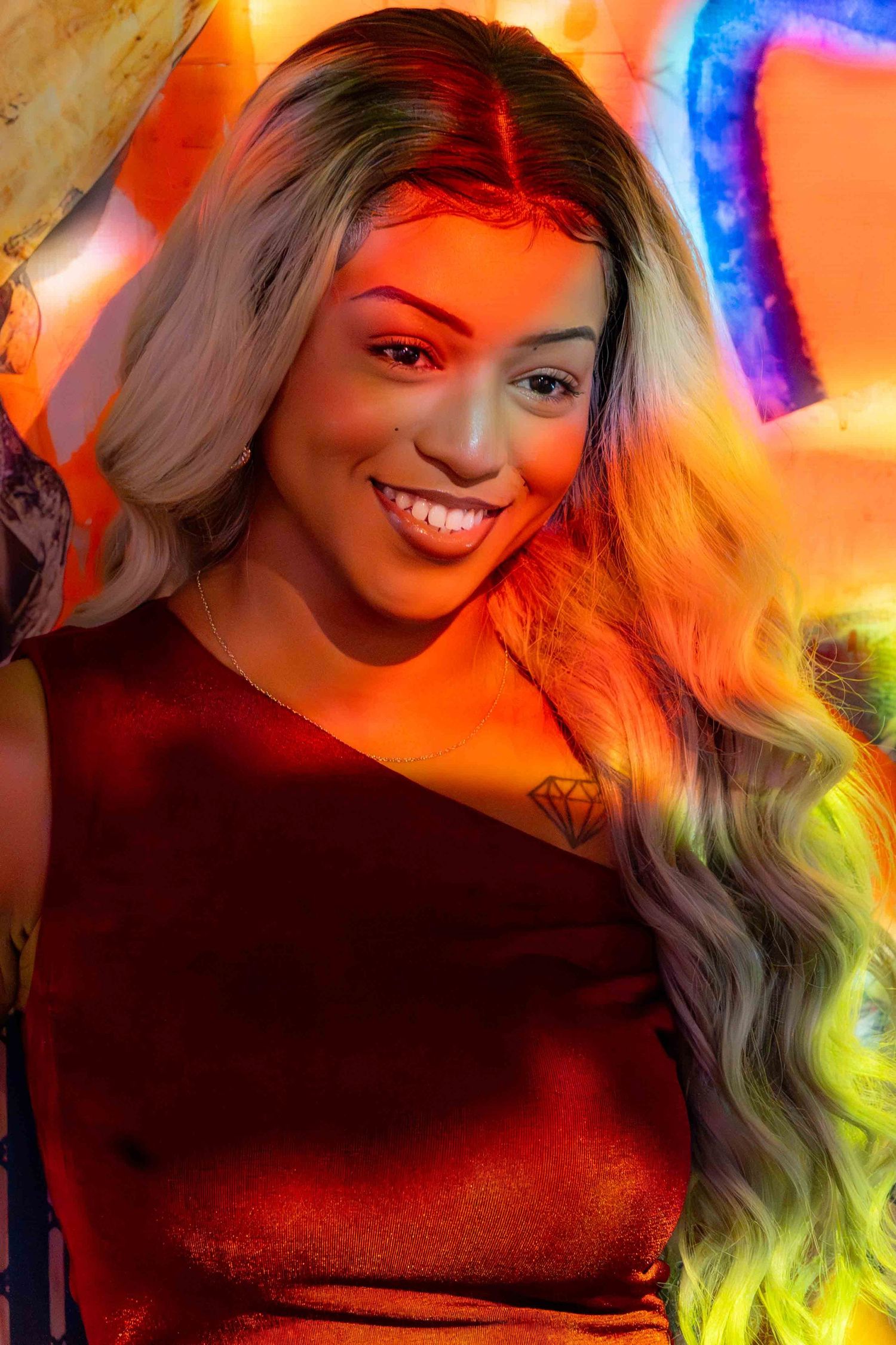 Portrait with vibrant orange and blue lighting effects creating a dreamy atmosphere.