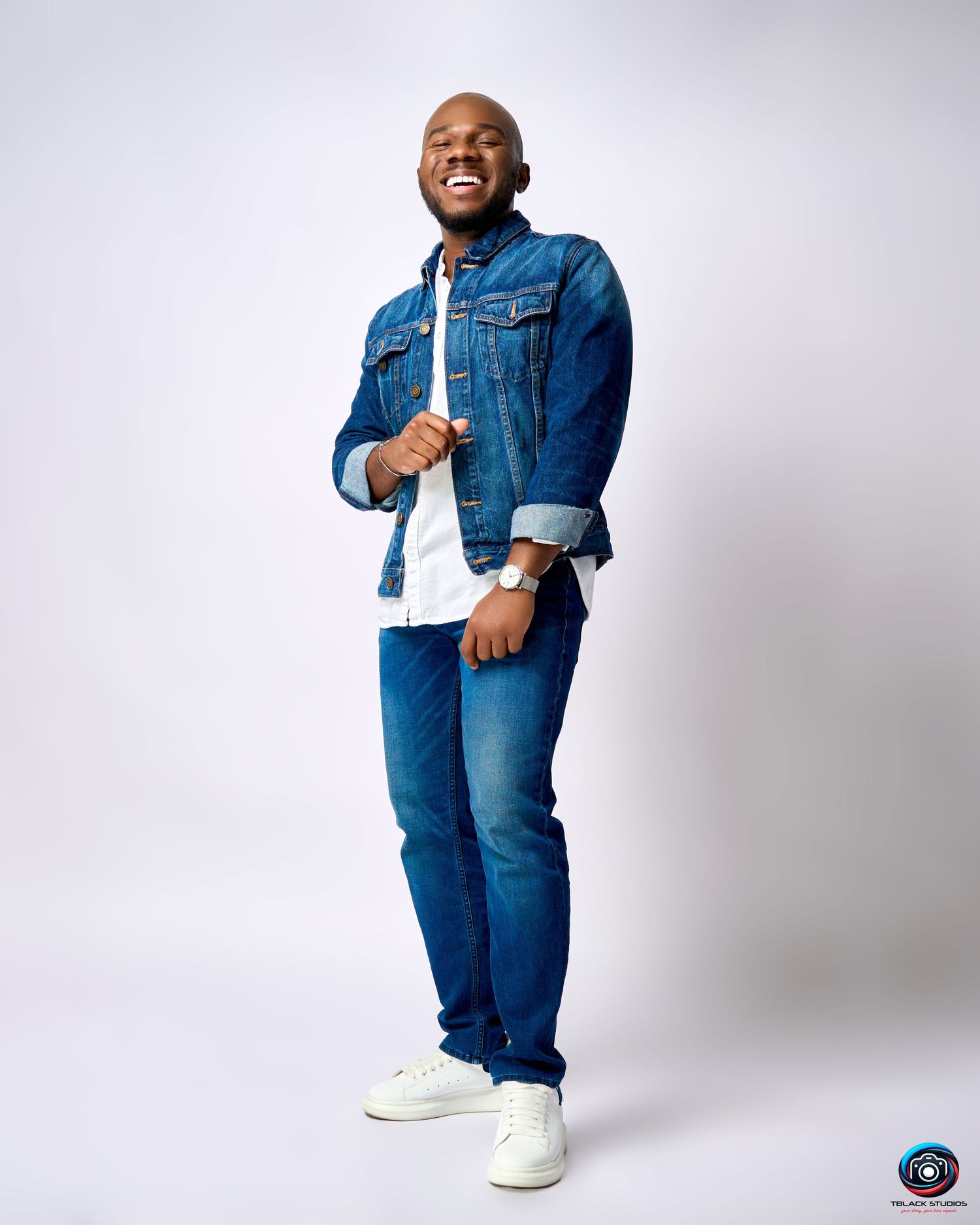 Model wearing denim jacket and jeans strikes various poses in studio setting.