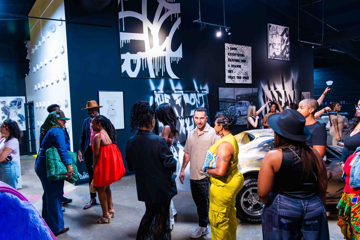 Crowded nightclub scene with neon lighting and wall art.