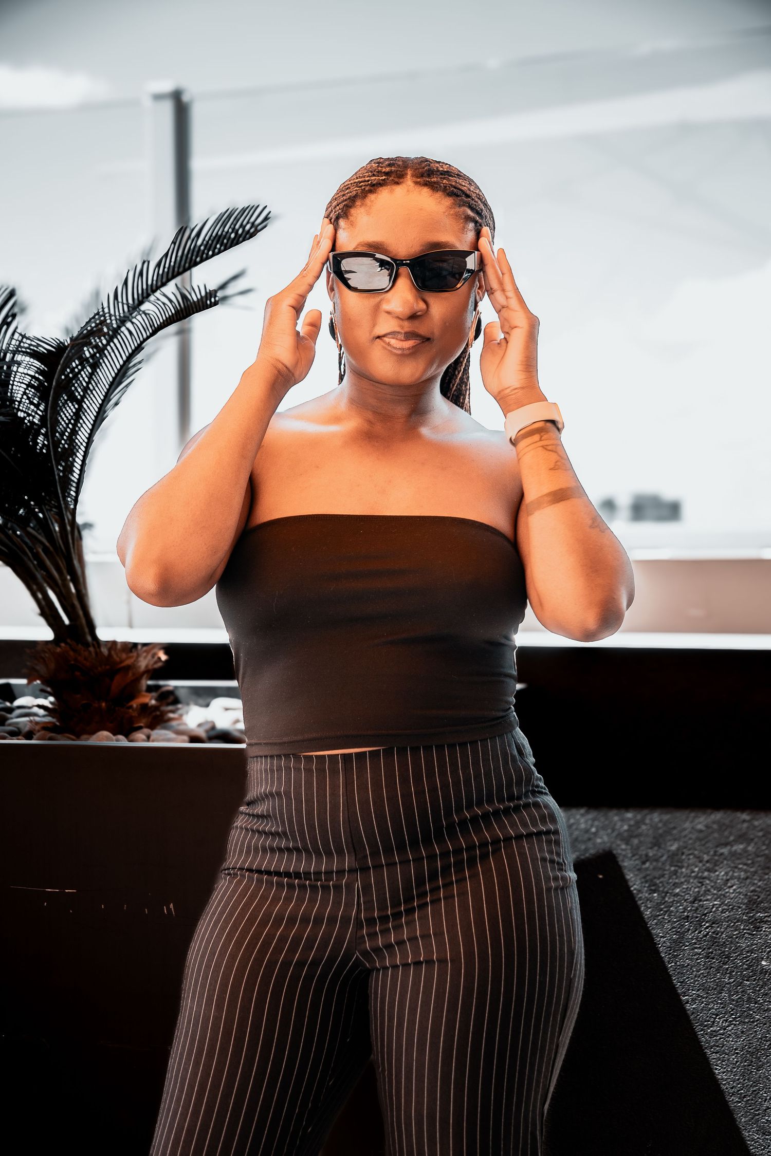 Stylish sunglasses and striped outfit captured in an editorial photoshoot.