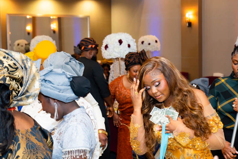 Celebration moments captured at African wedding reception with guests in formal attire.