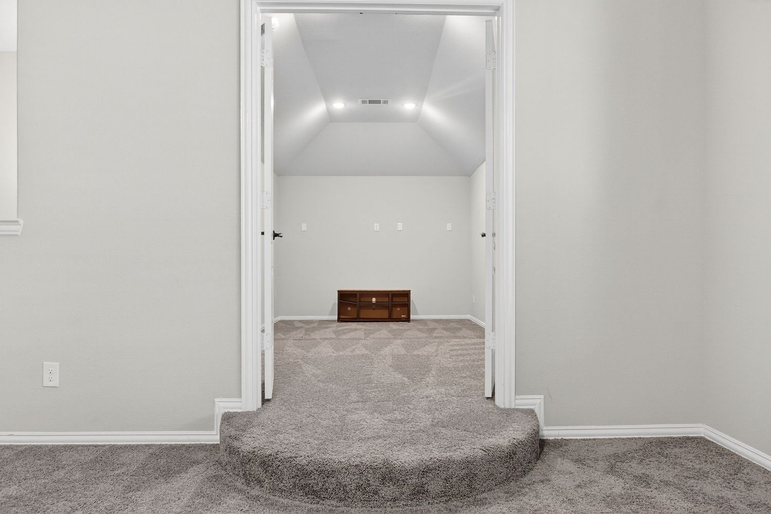 Empty hallway with light gray walls, white trim, and recessed lighting.