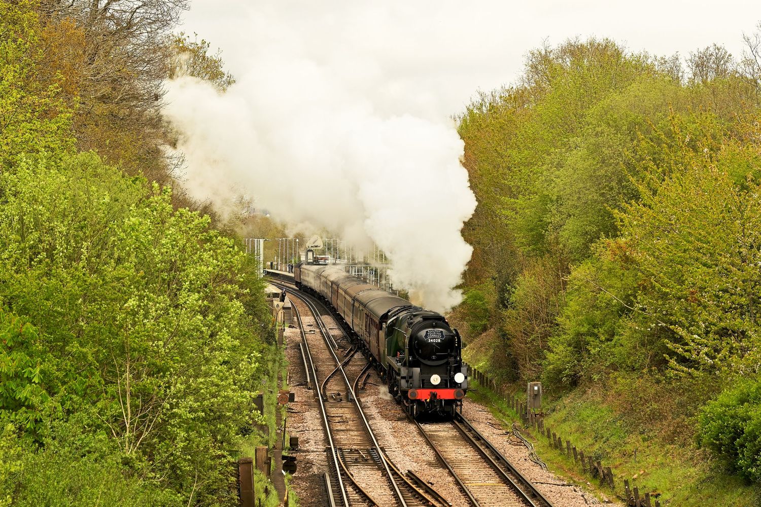 Eddystone 34028 steam locomotive passing through Wivelsfield as scenic railway photography available as wall art prints.