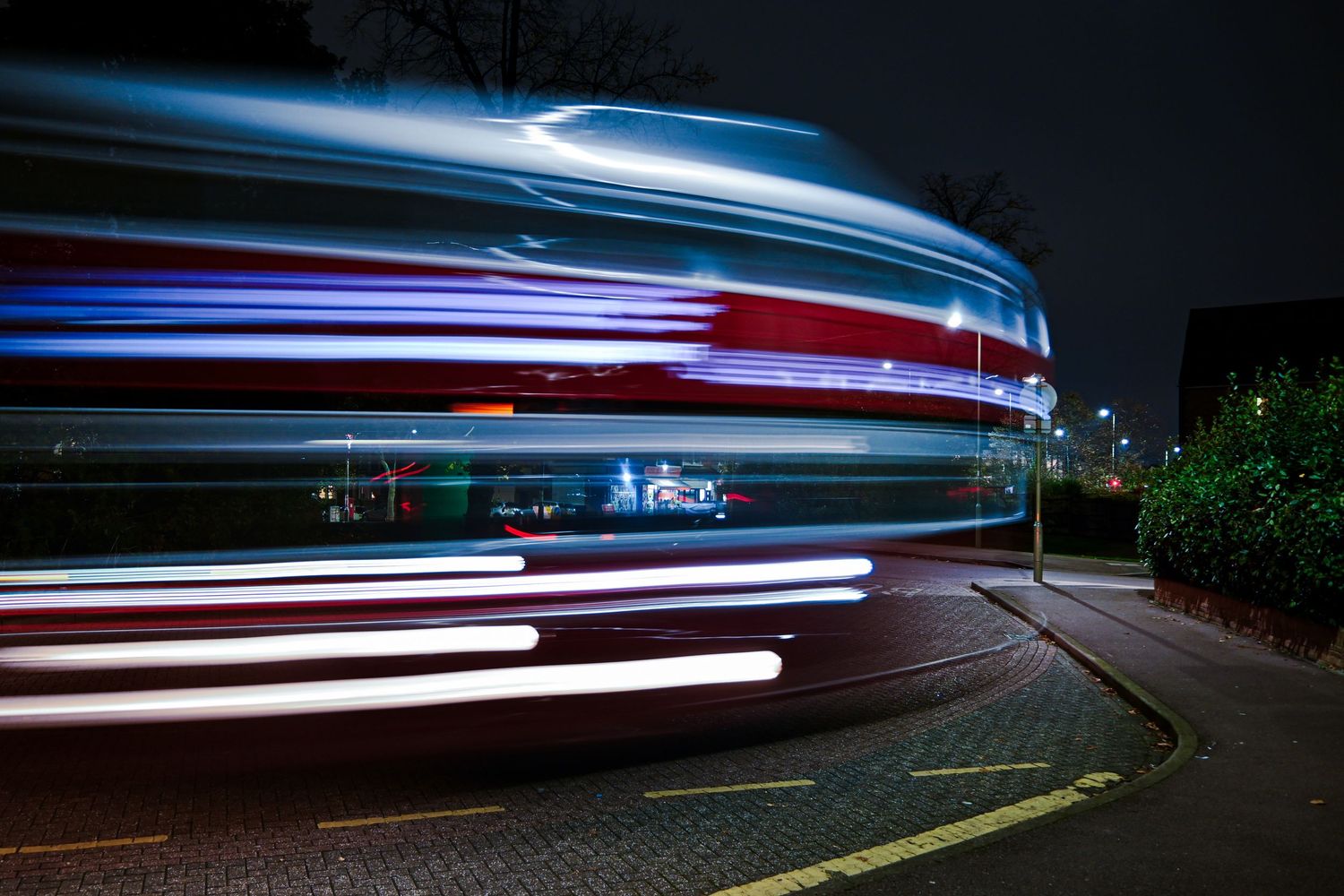A heritage double decker bus departs Friern Barnet as light trails photography available as fine art wall prints.