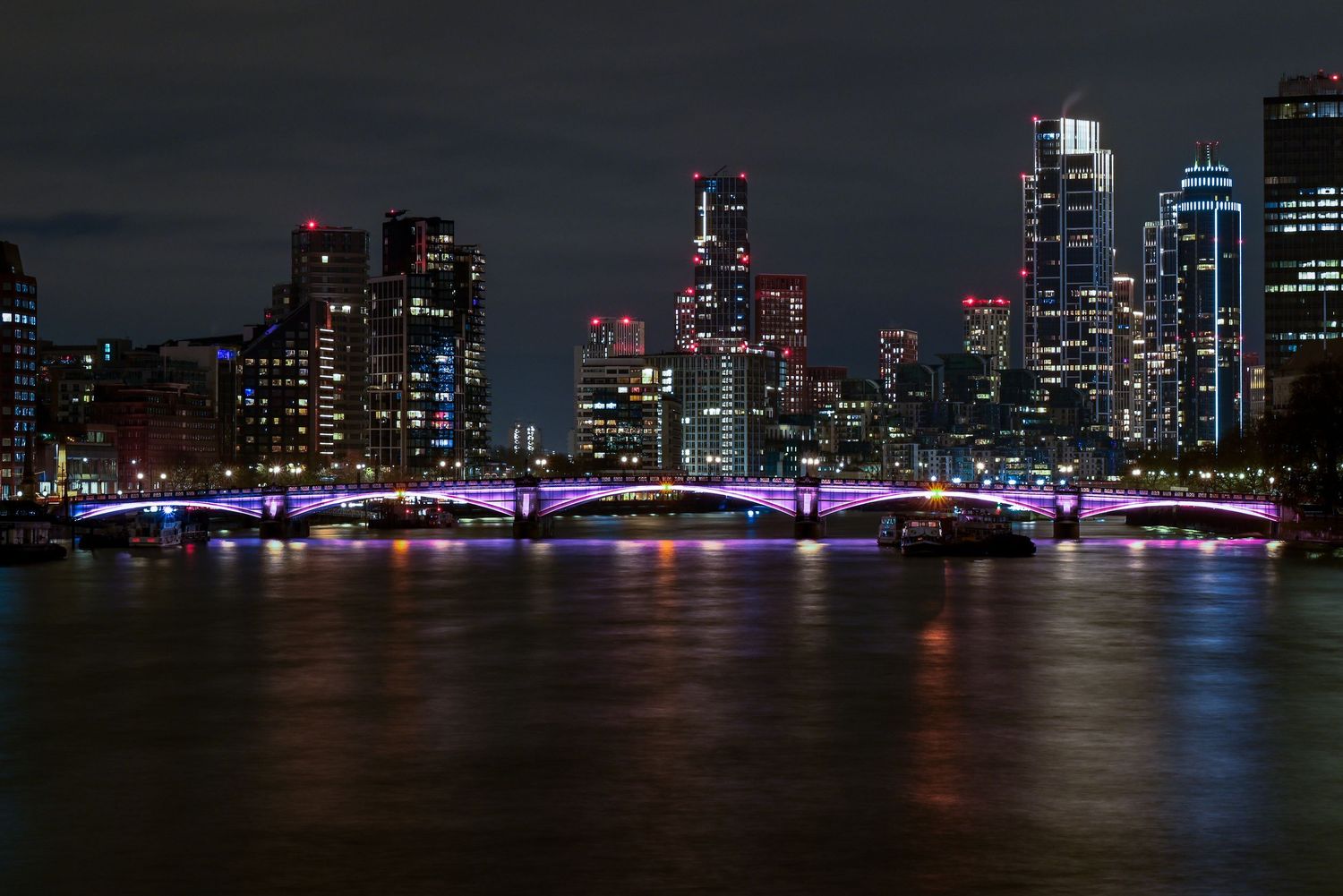 London city bridge & buildings during night time as city photography available as fine art wall prints.