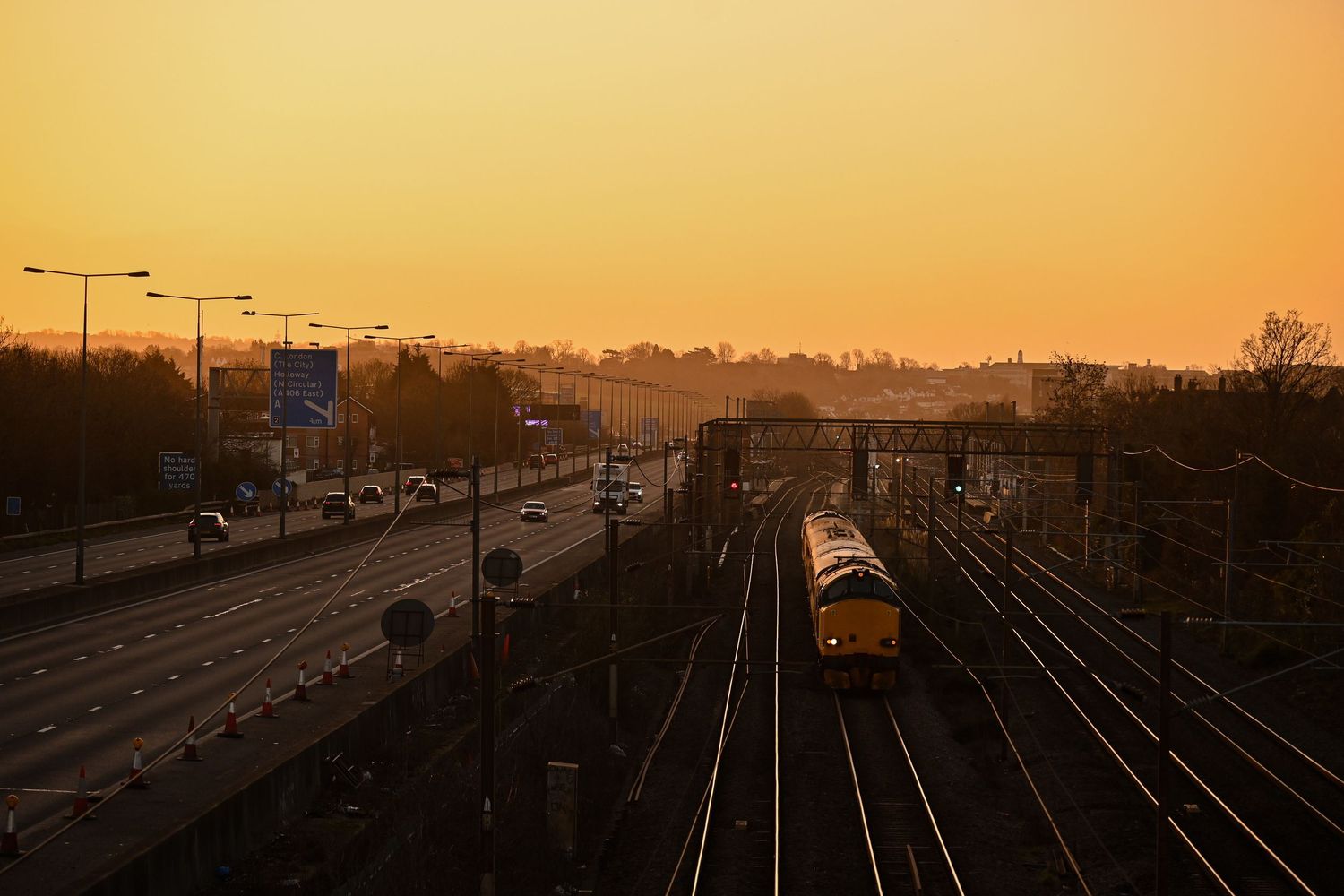 Class 37 passing through Mill Hill Broadway during sunrise as scenic railway photography is available as fine art wall prints.