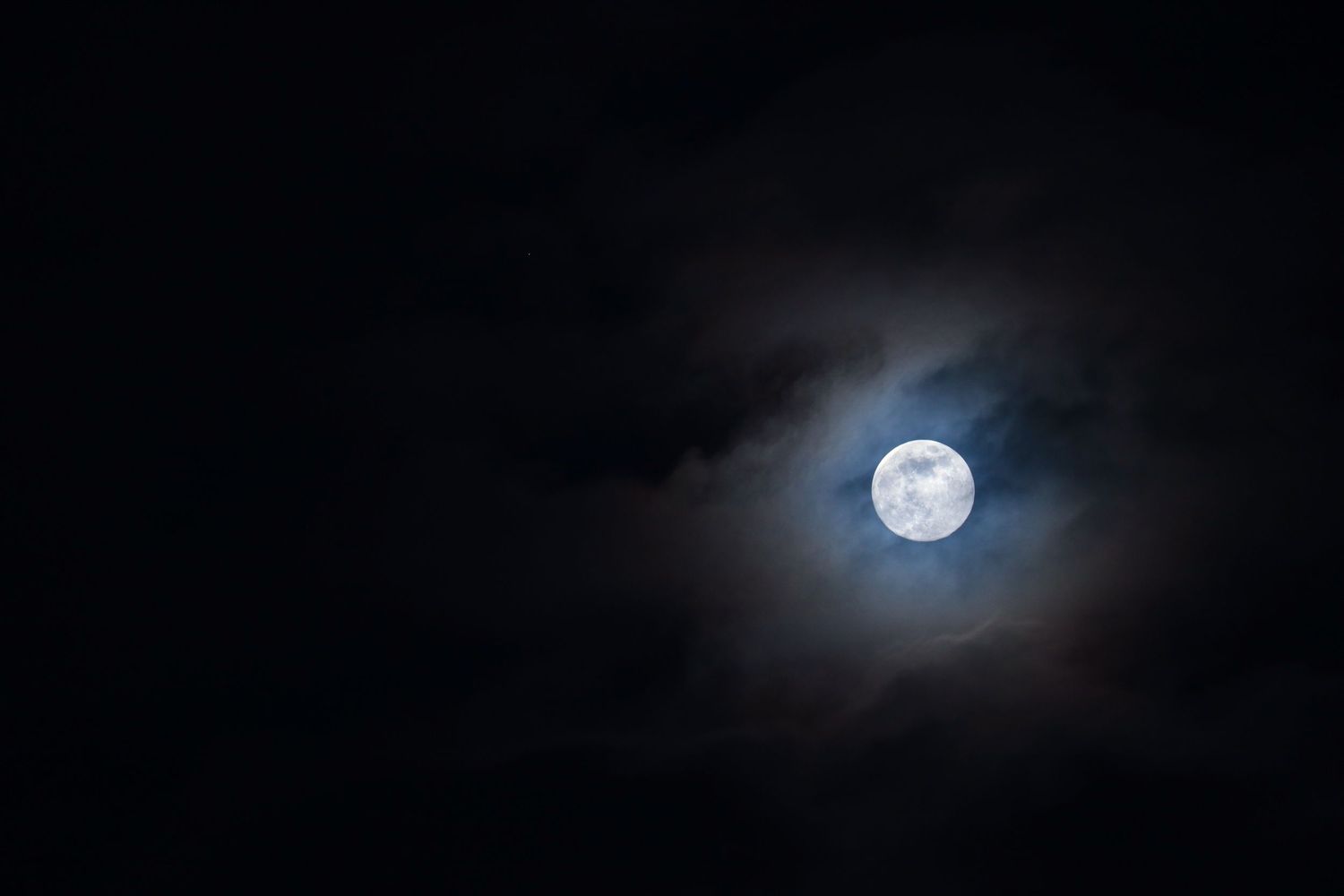 Full moon as the clouds makes space as moon photography available as fine art wall prints.