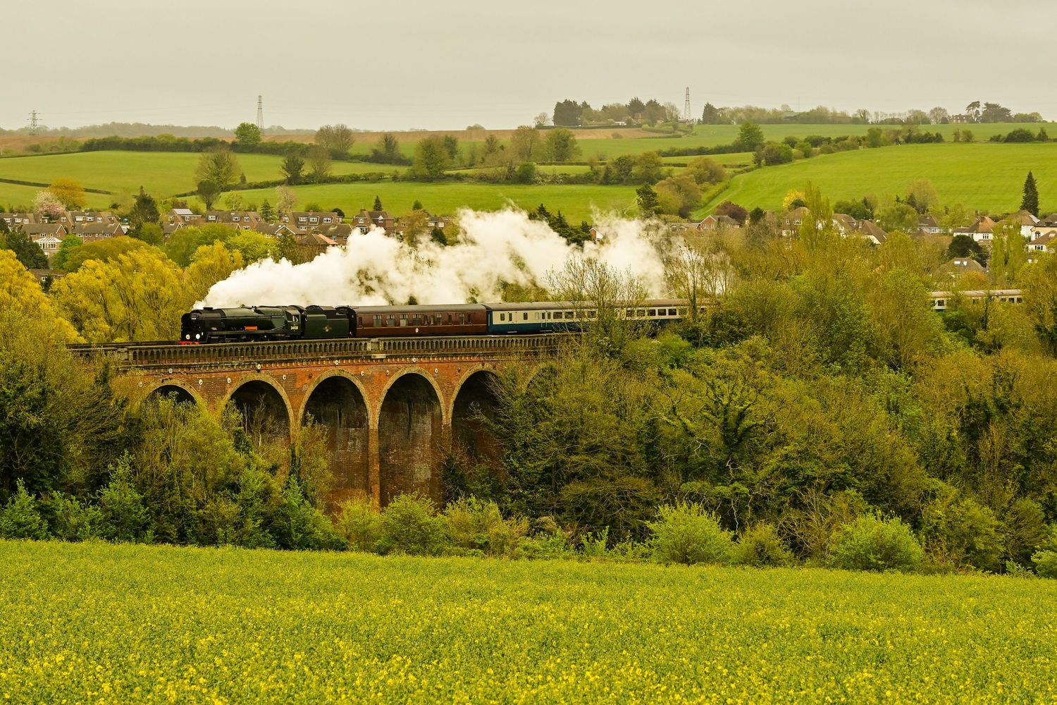 Eddystone 34028 steam locomotive crosses over Eynsford viaduct as scenic railway photography available as wall art prints.