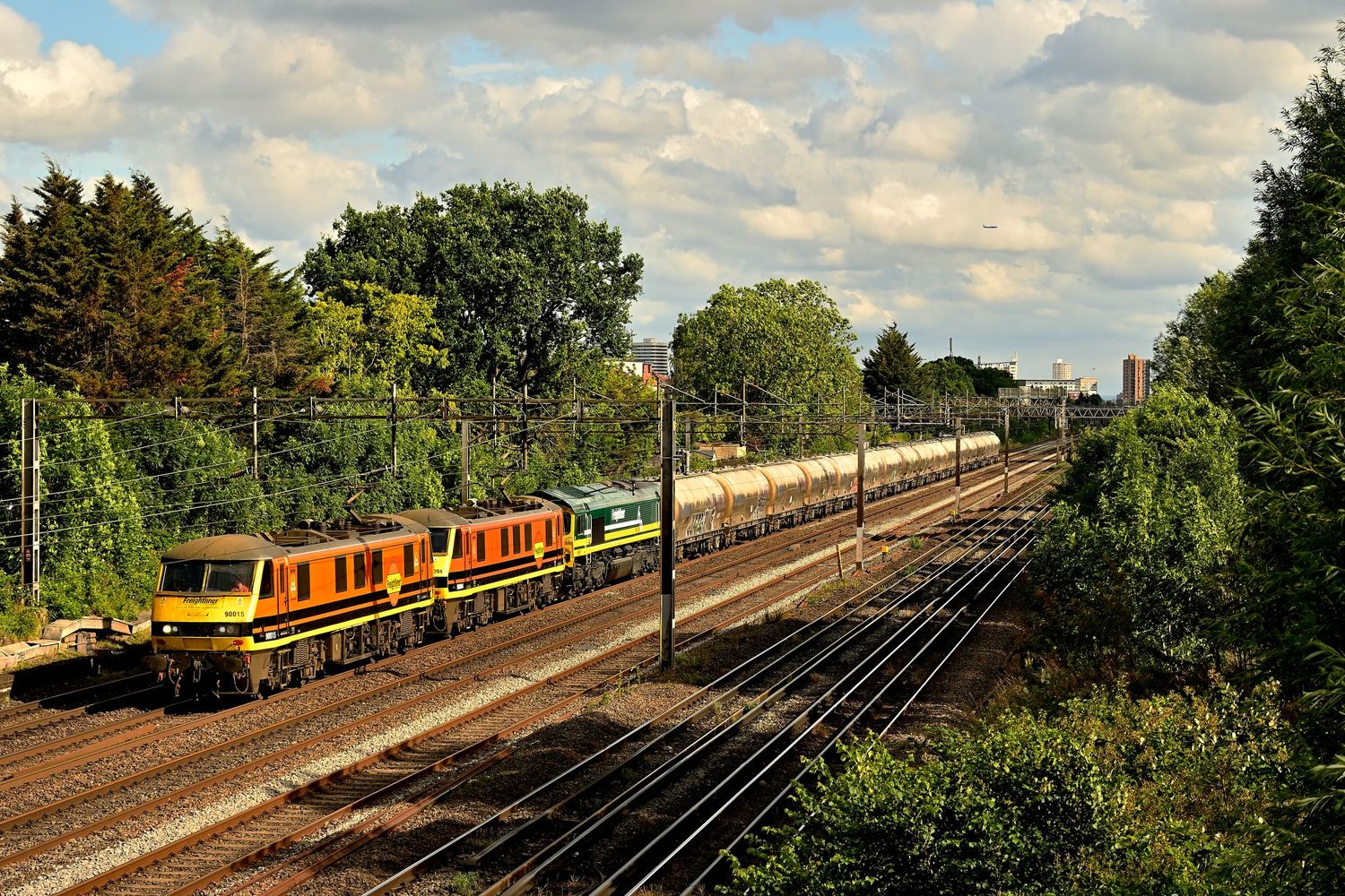 Triple Header freightliner locomotives cements train during an overcast day as scenic railway photography available as wall art prints.