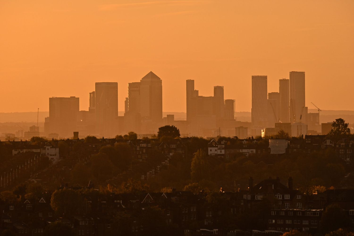 Sunrise at Canary Wharf from a far distance as landscape photography available as fine art wall prints.