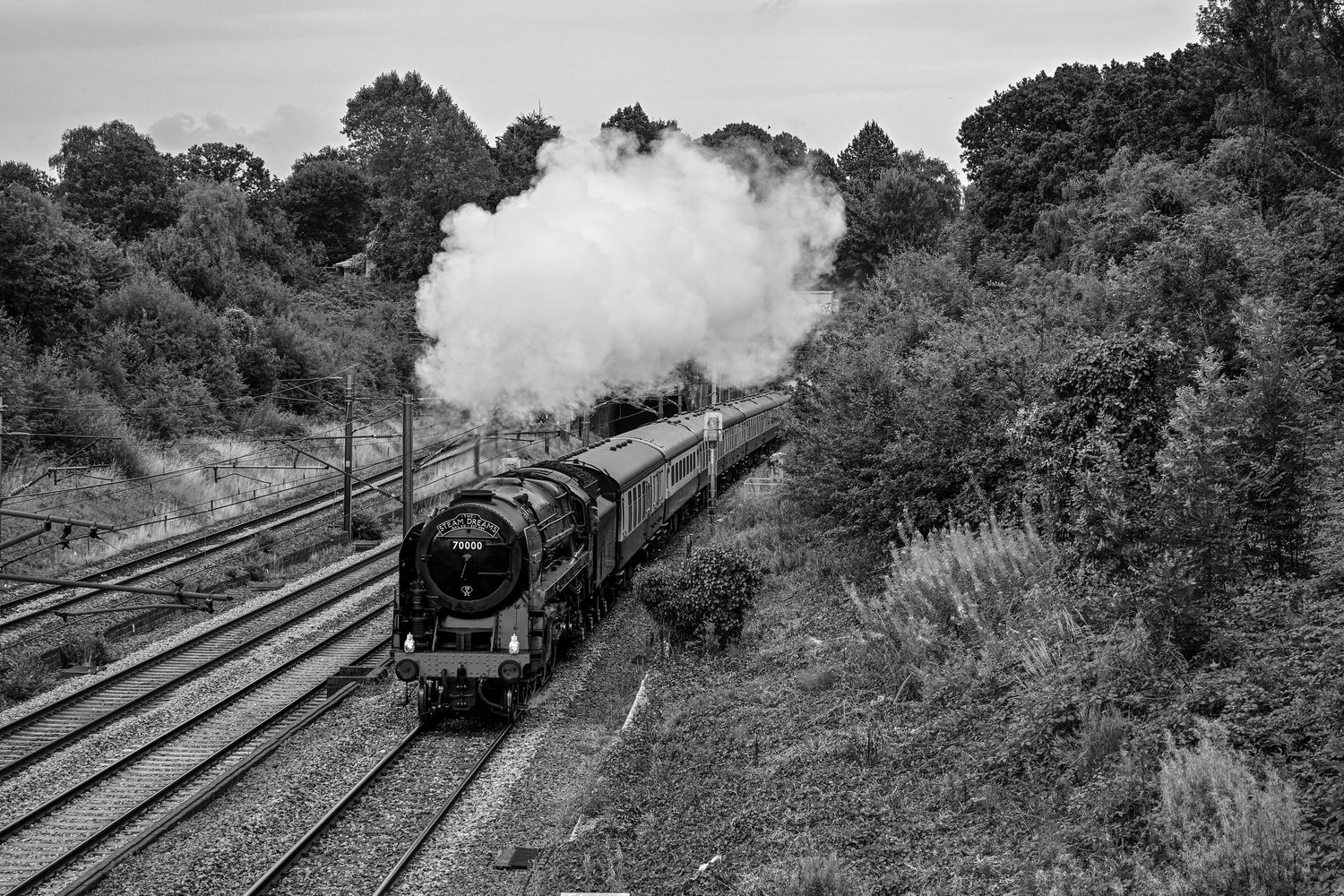 Britannia 70000 steam locomotive passing through Oakleigh Park as scenic railway monochrome photography available as fine art wall prints.