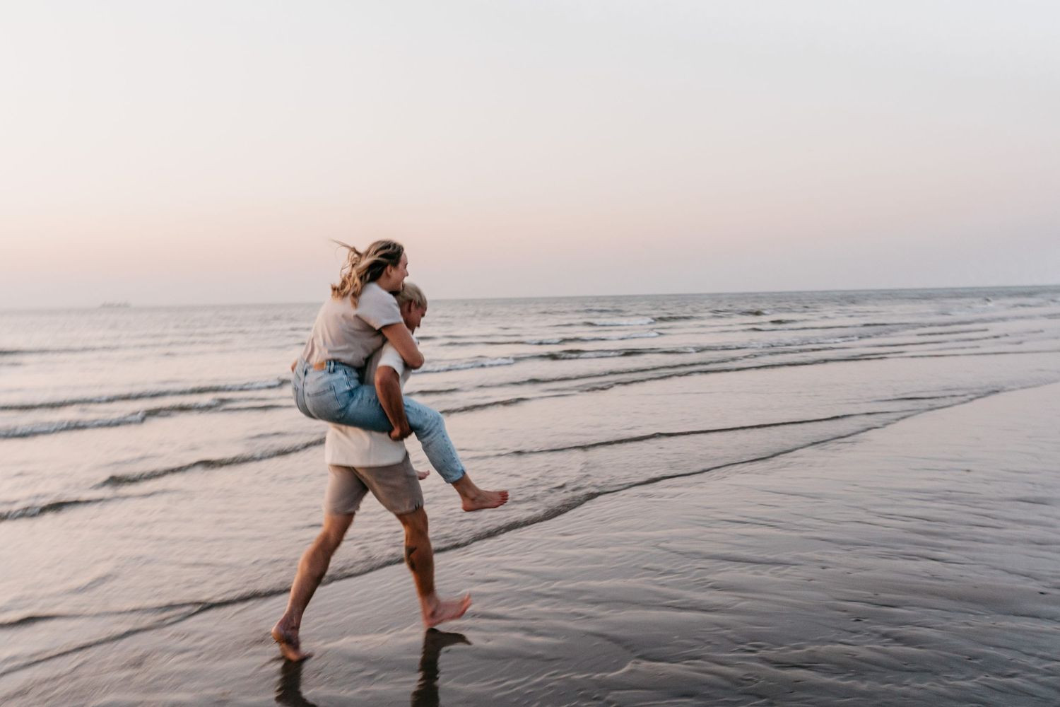 Adventurous couple shoot at the beach during sunset