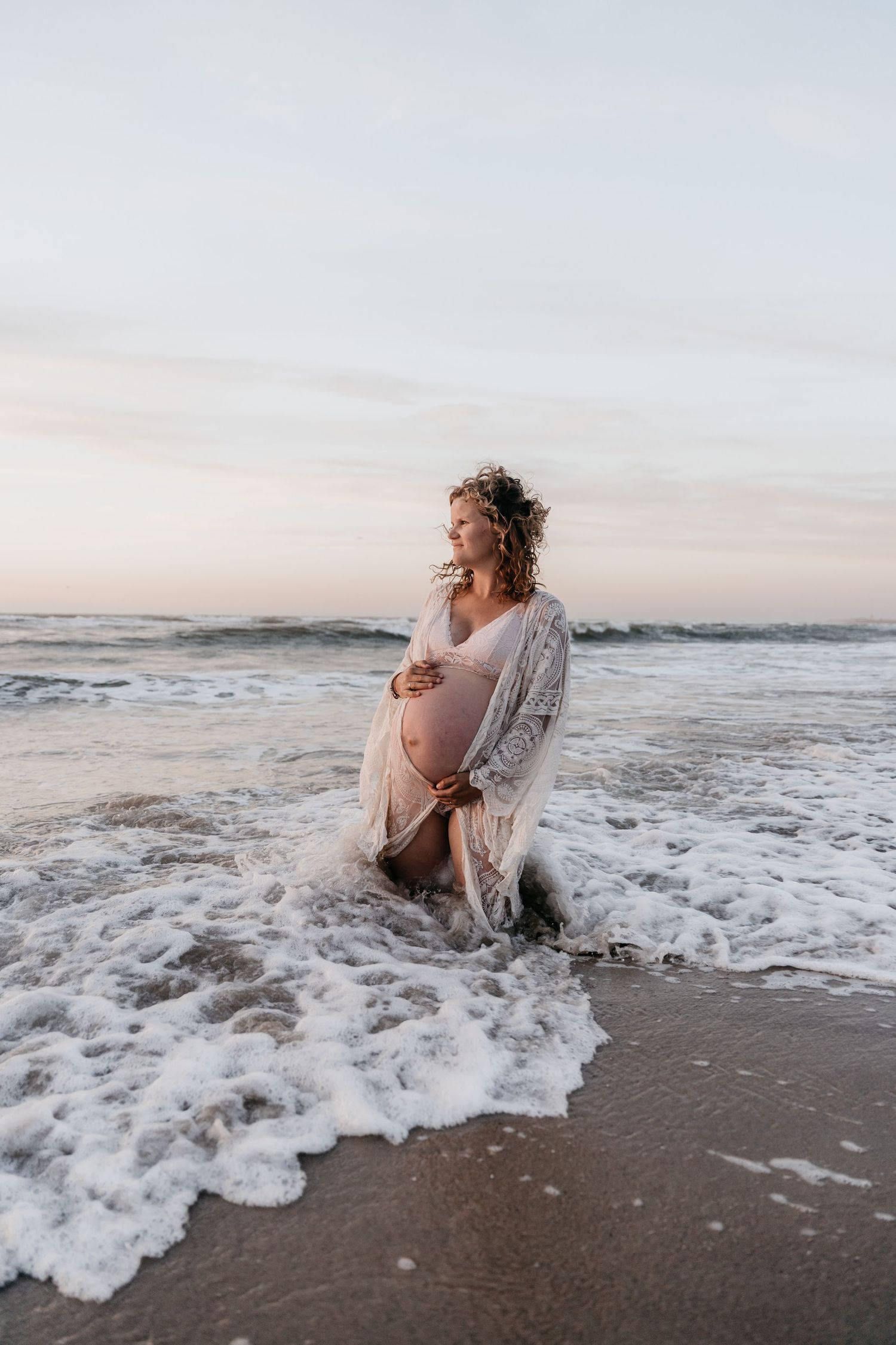 Maternity shoot at the beach in the sea during golden hour - Monster - The Netherlands