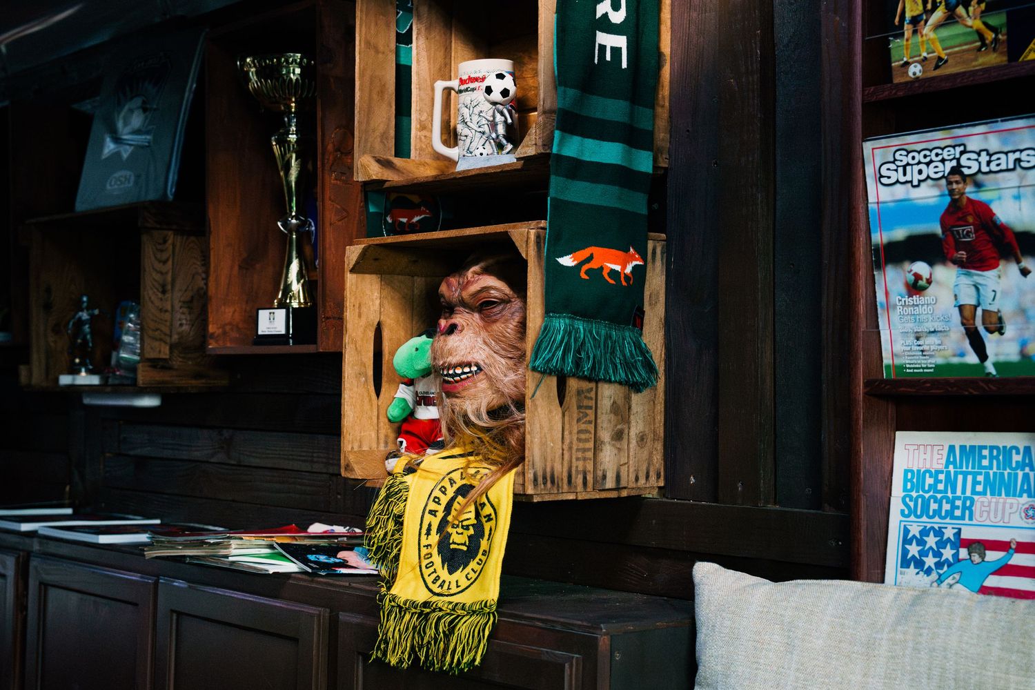 A colorful wall display featuring posters, artwork and decorative elements in what appears to be a retail or cafe setting.