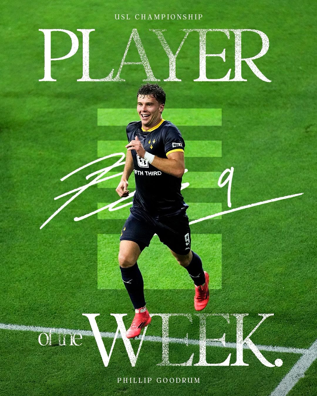 Soccer player in dark uniform runs across a bright green field during championship match.