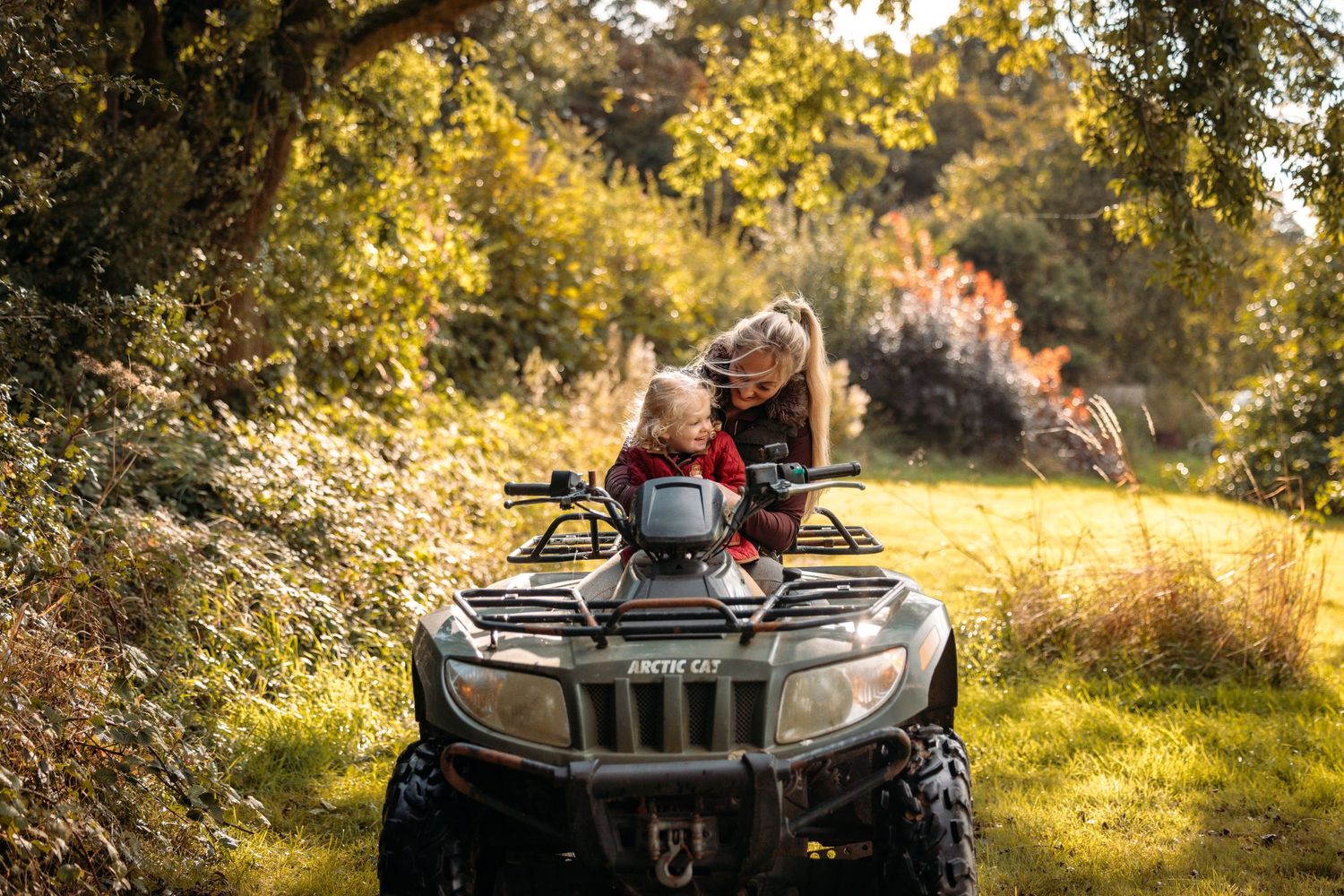 Group enjoying outdoor adventure on ATV in autumn scenery.